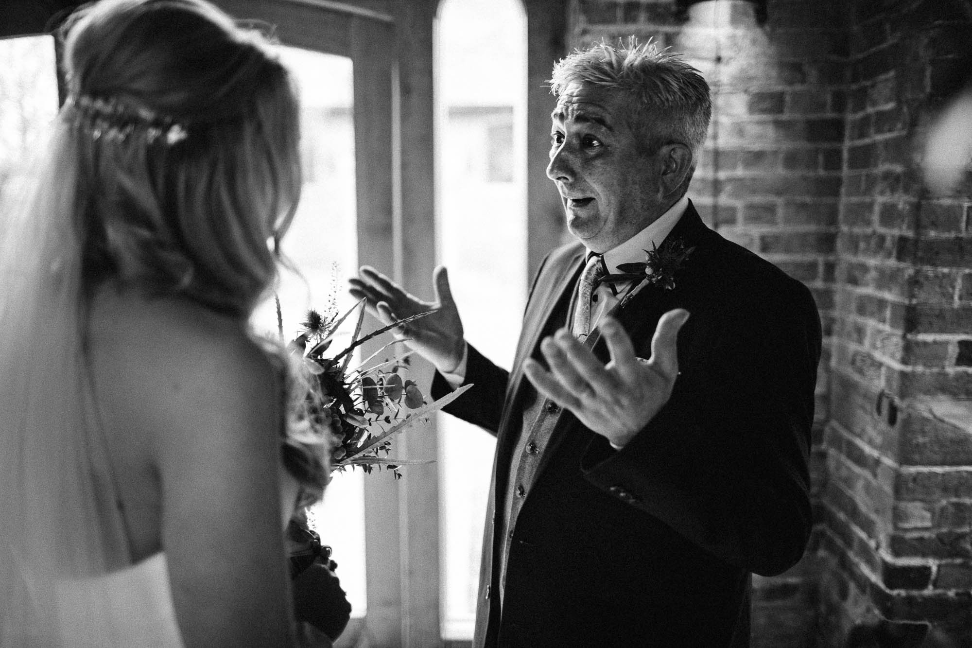 Father of bride shows his joy to Bride after wedding