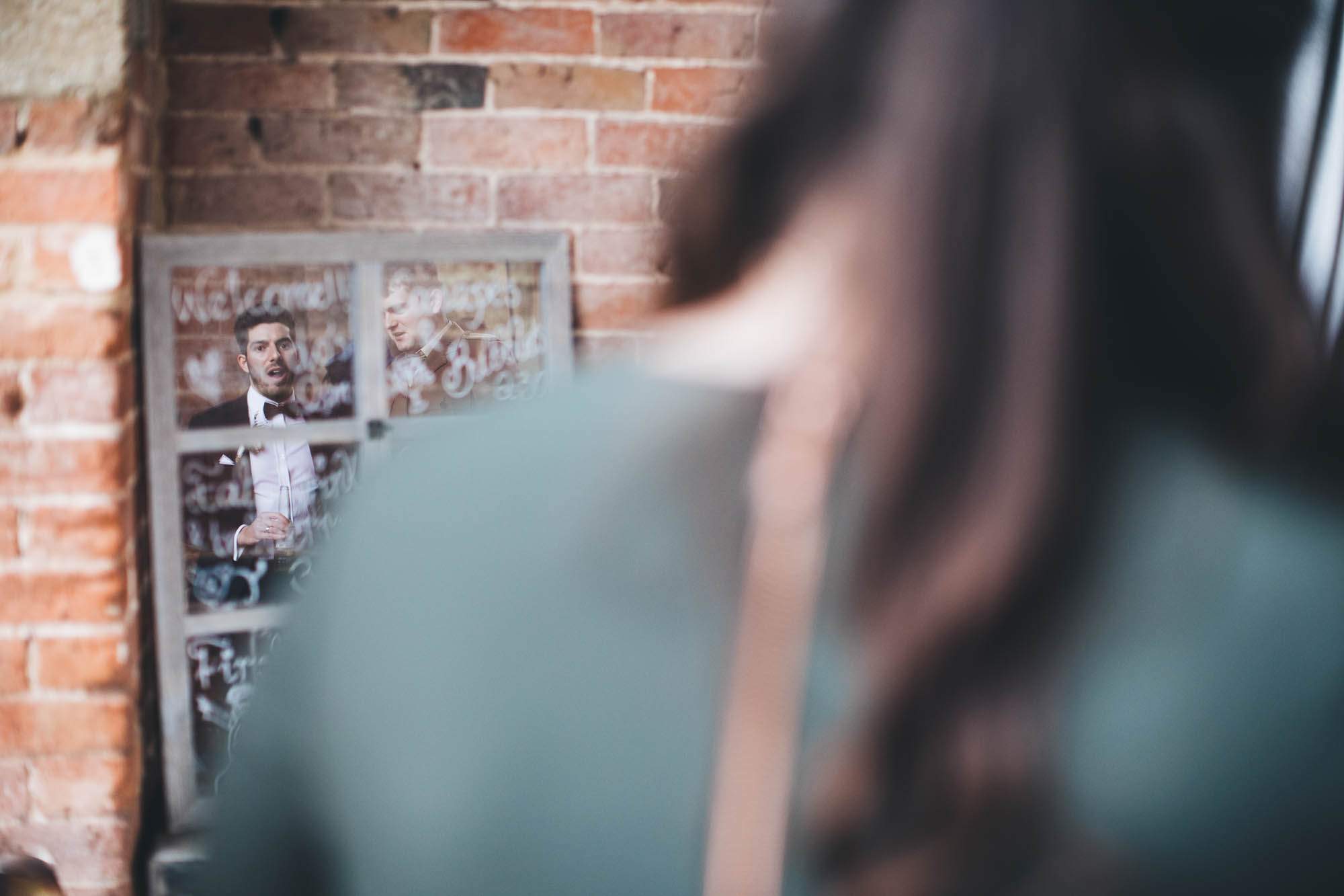 Reflection of Groom in Wedding Welcome mirror