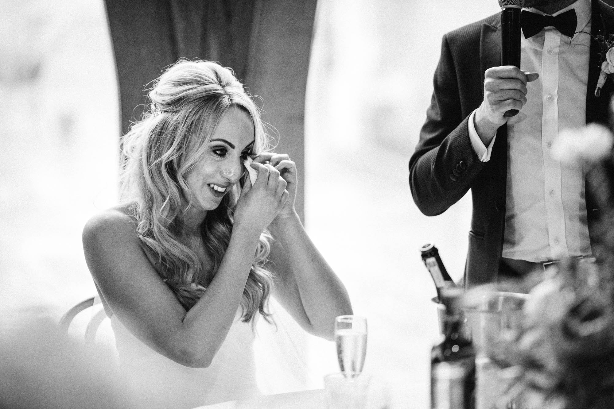 Bride wipes away tears after emotional wedding speech