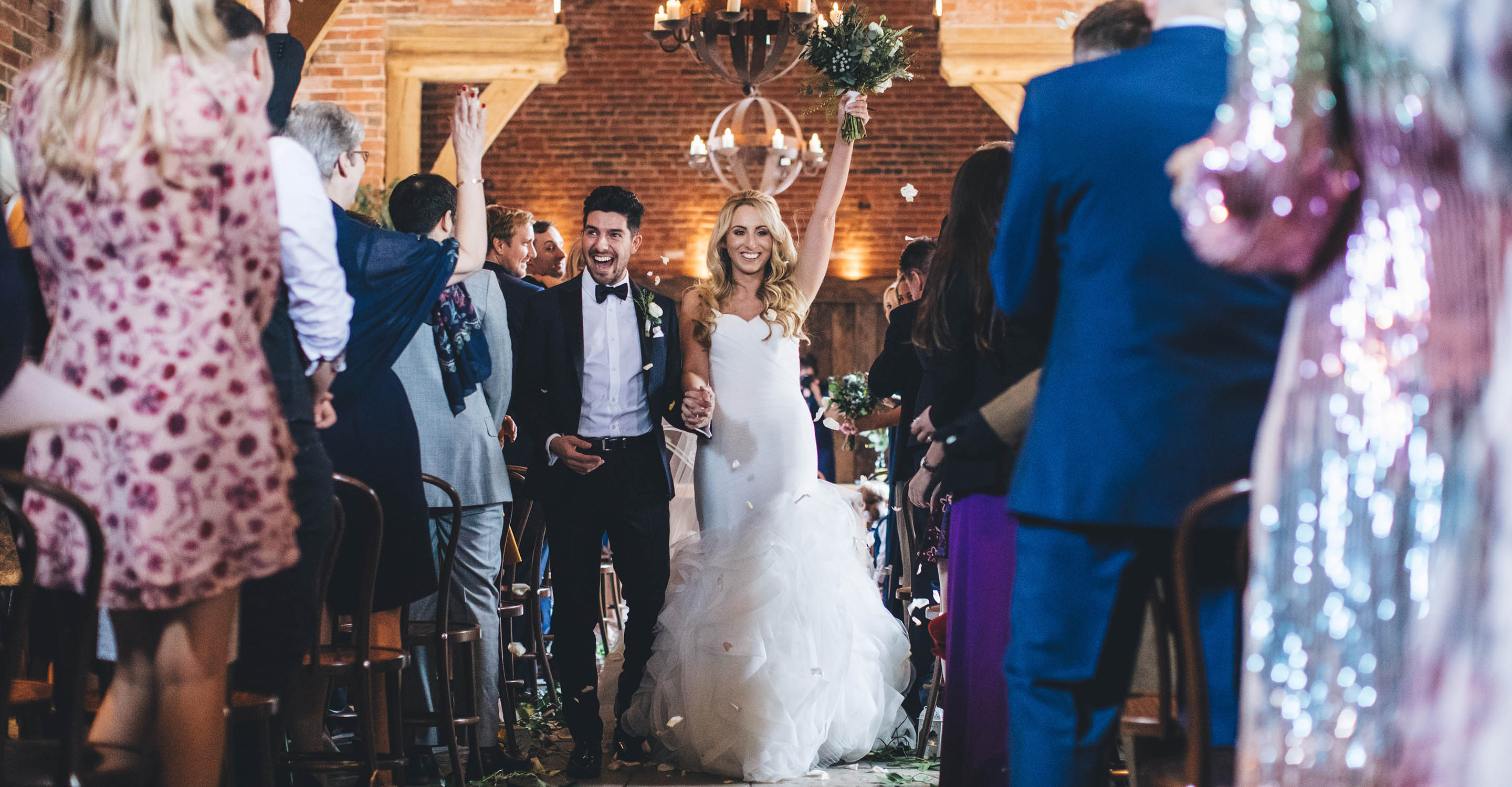 shustoke barn couple walkingback down the aisle after their wedding ceremony