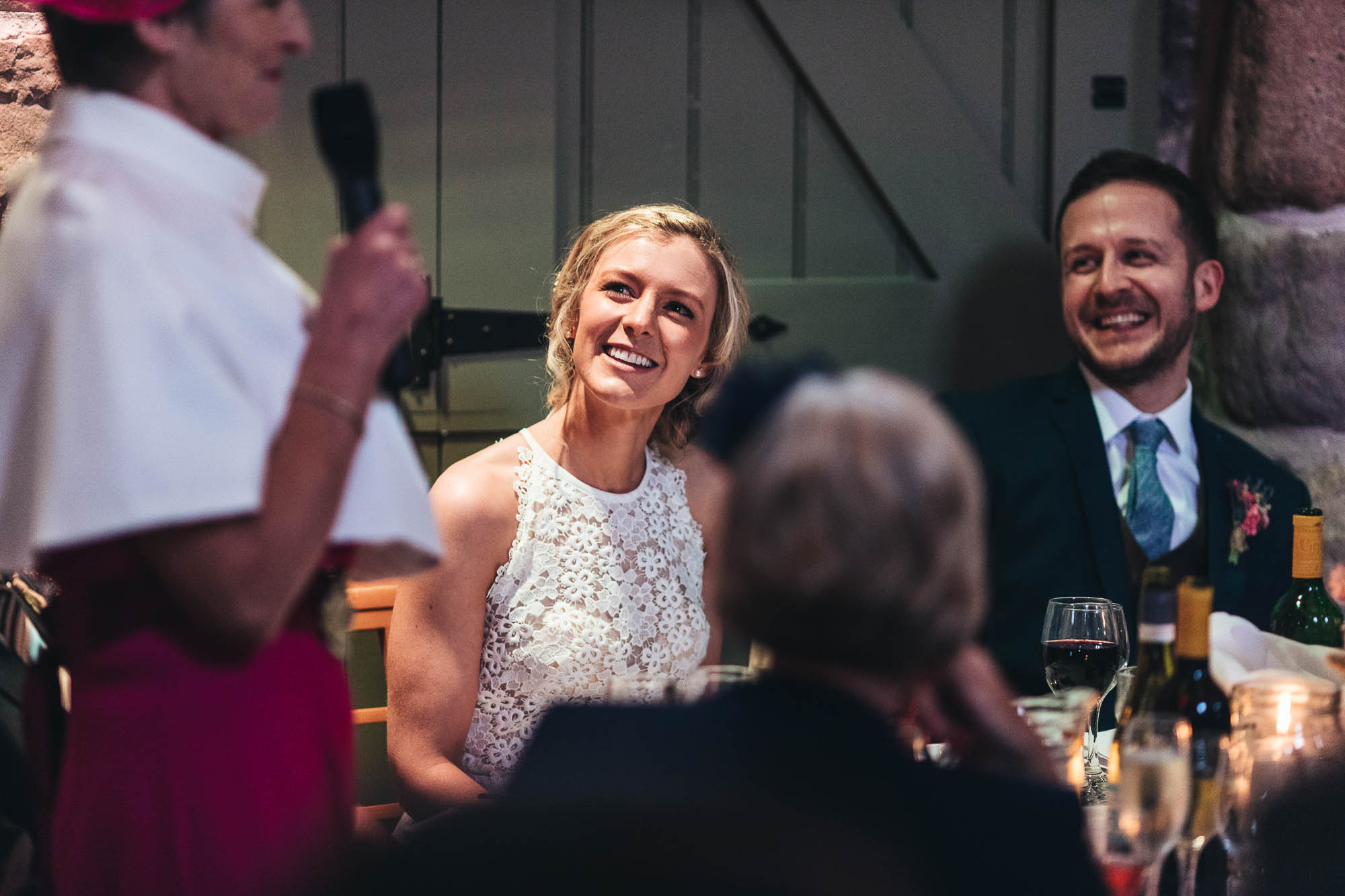 Bride and Groom are amused by wedding speech