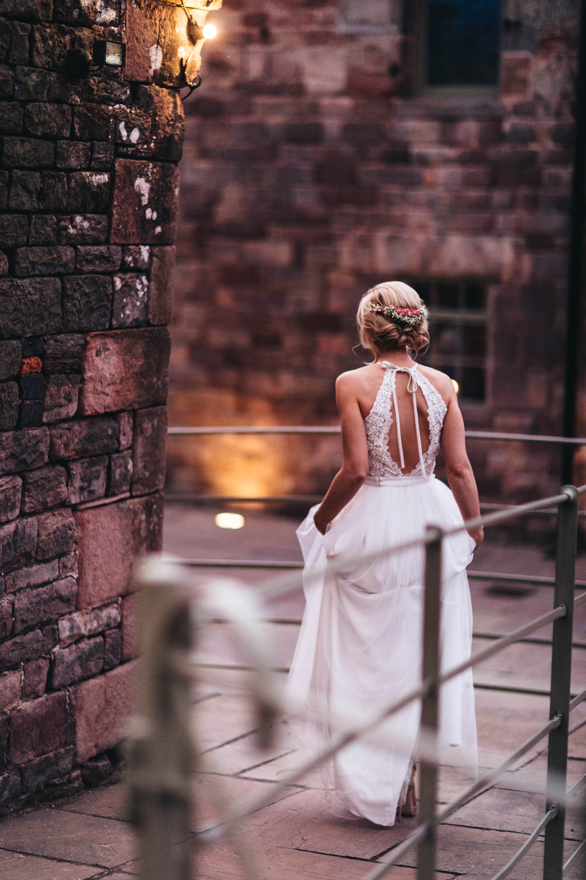 Shot to feature the back of Bride's wedding dress as she walks back inside the Wedding Barn