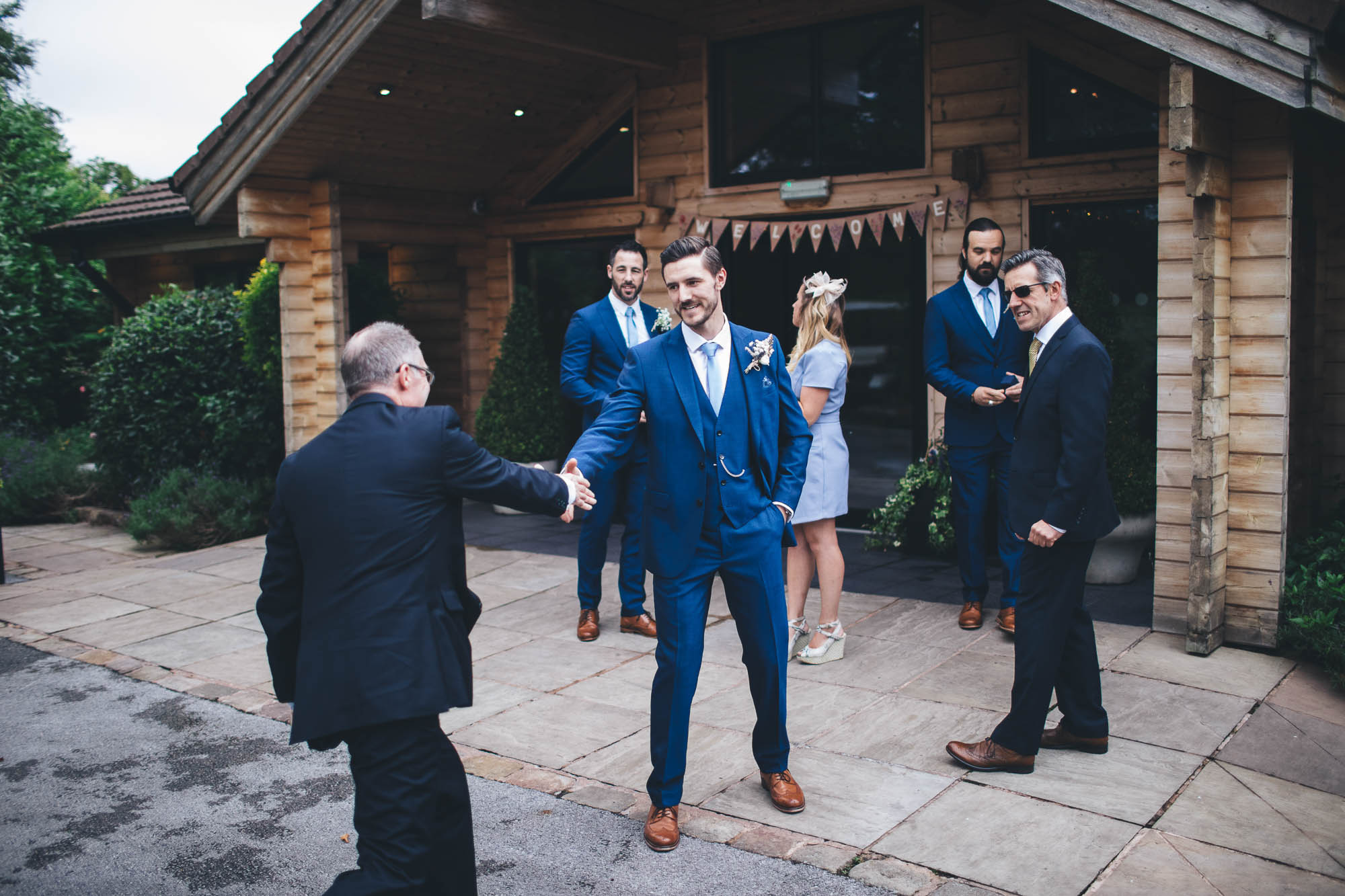 GROOM SHAKES HAND OF GUEST
