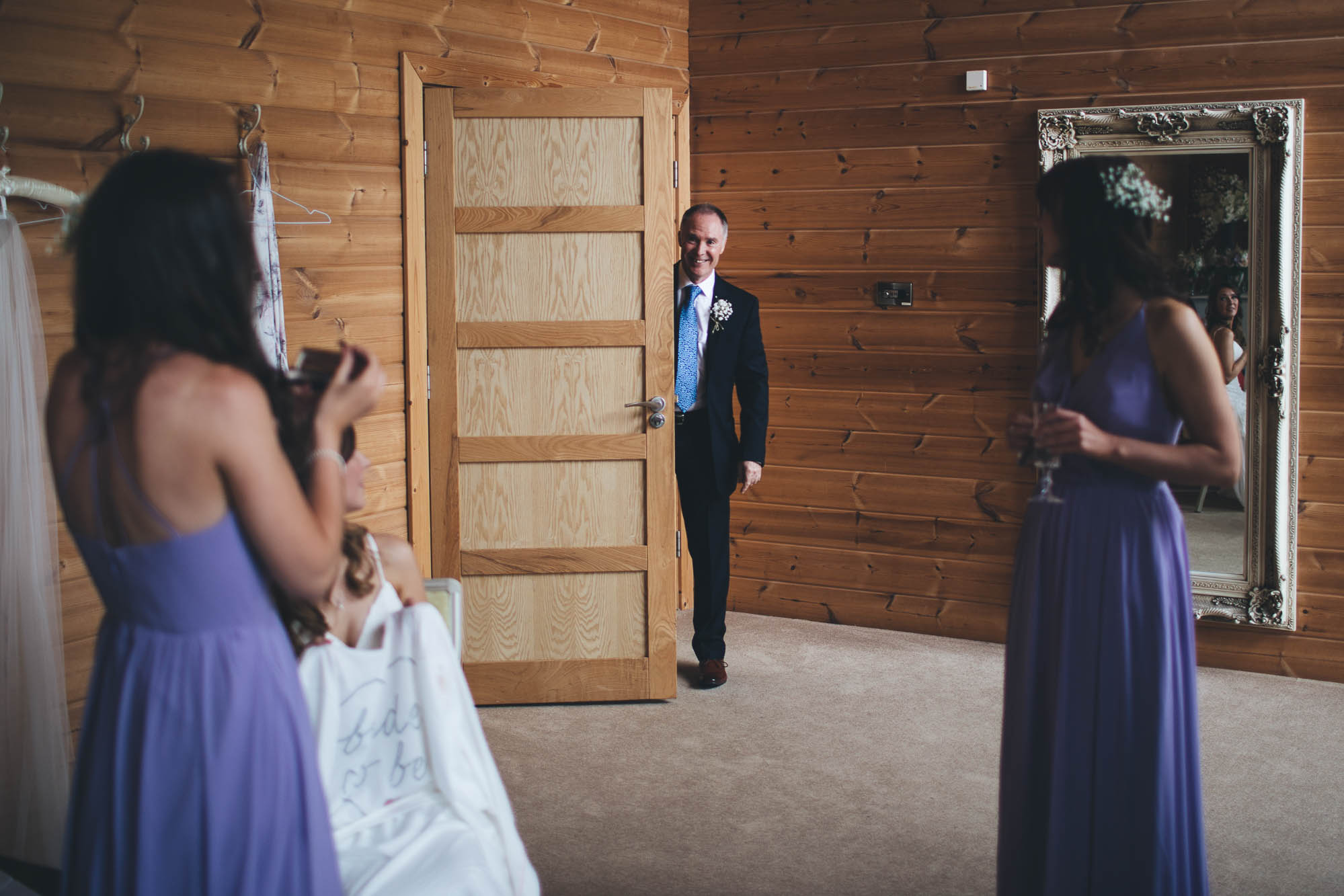 FATHER OF THE BRIDE PEERING AROUND THE DOOR SMILING TO SAY HELLO
