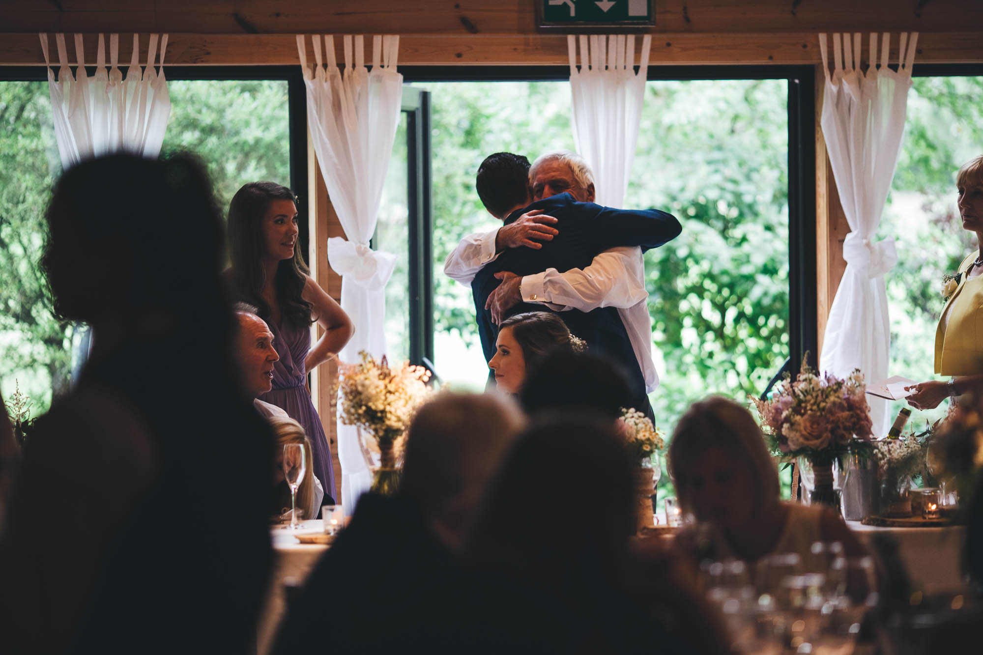 HUGS WITH GROOM AND FATHER