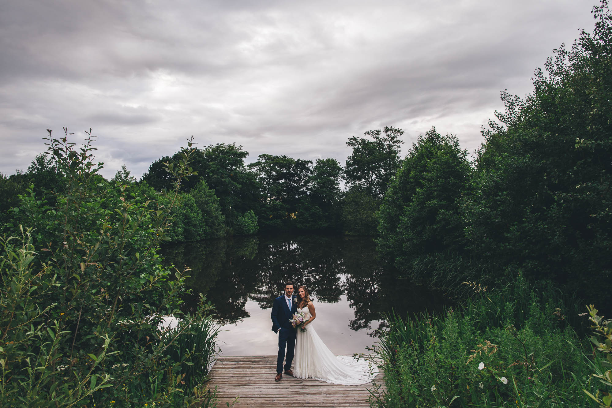 PORTRAIT OF COUPLE BY THE LAKE AT STYAL LODGE