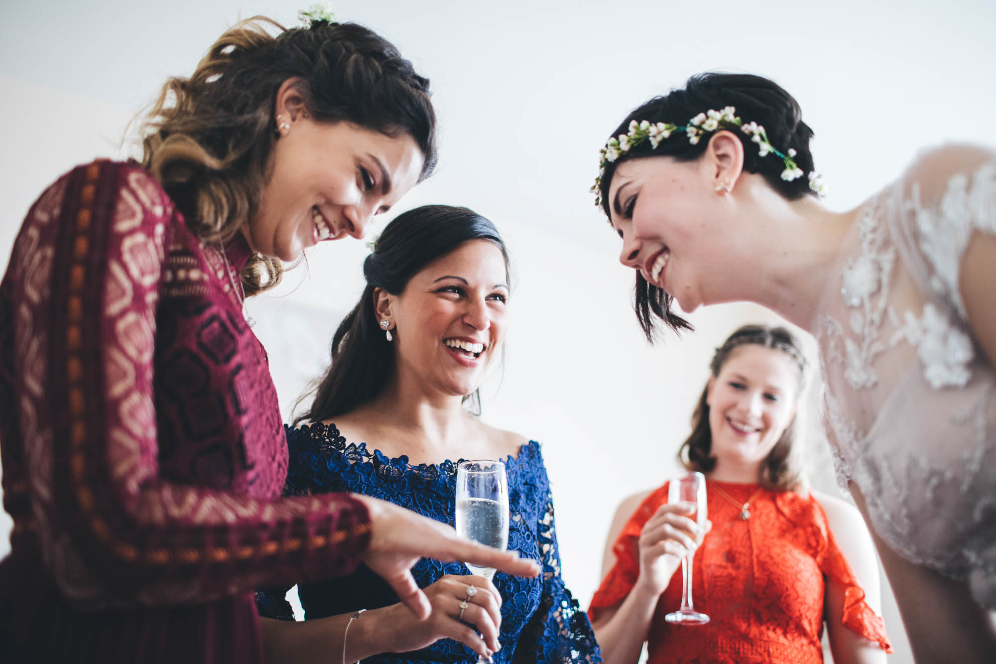 bride with her maids on the wedding morning preparing
