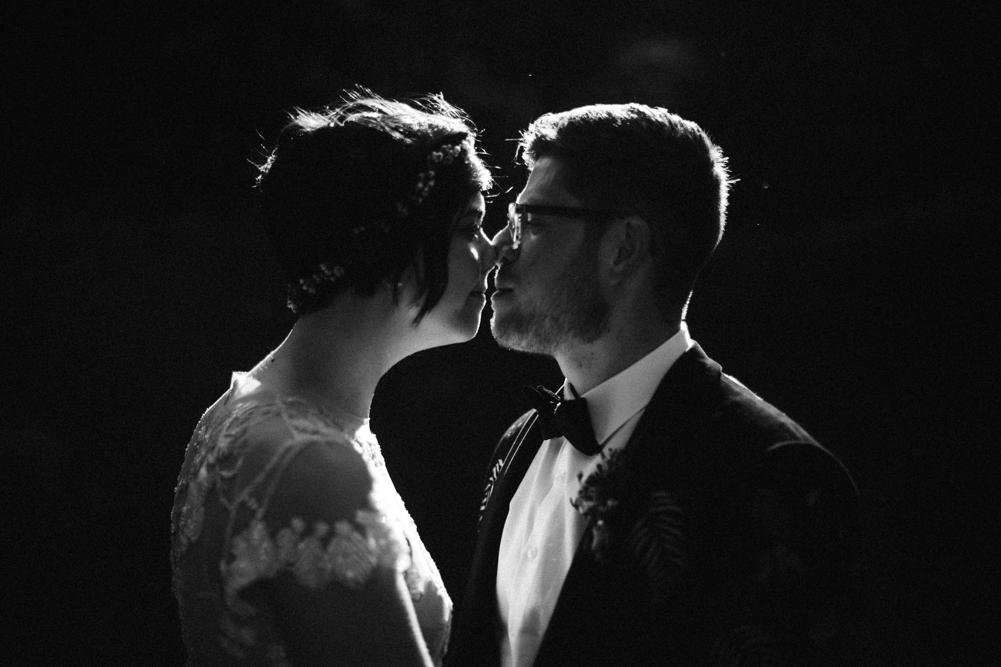 portrait of couple in black and white backlit by the sun