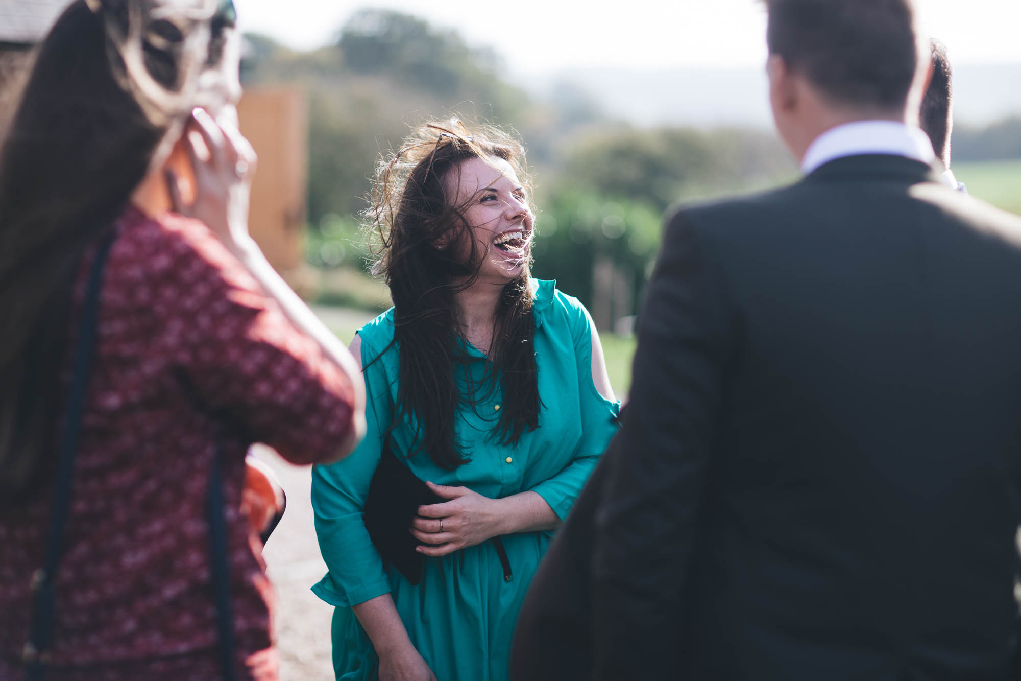 fun candid shot of wedding guest laughing