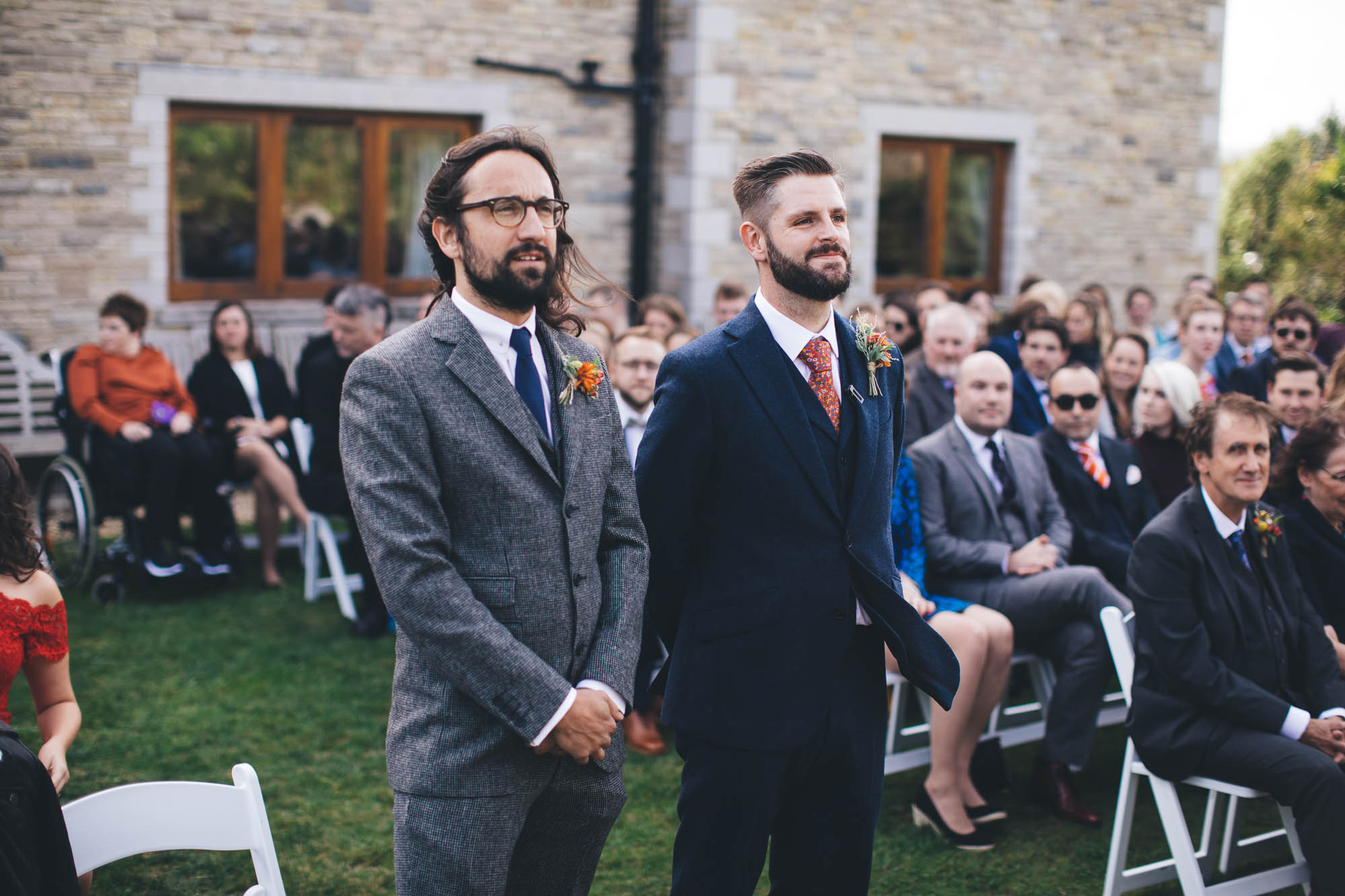 groom and best man look serious as they wait for the wedding ceremony to start