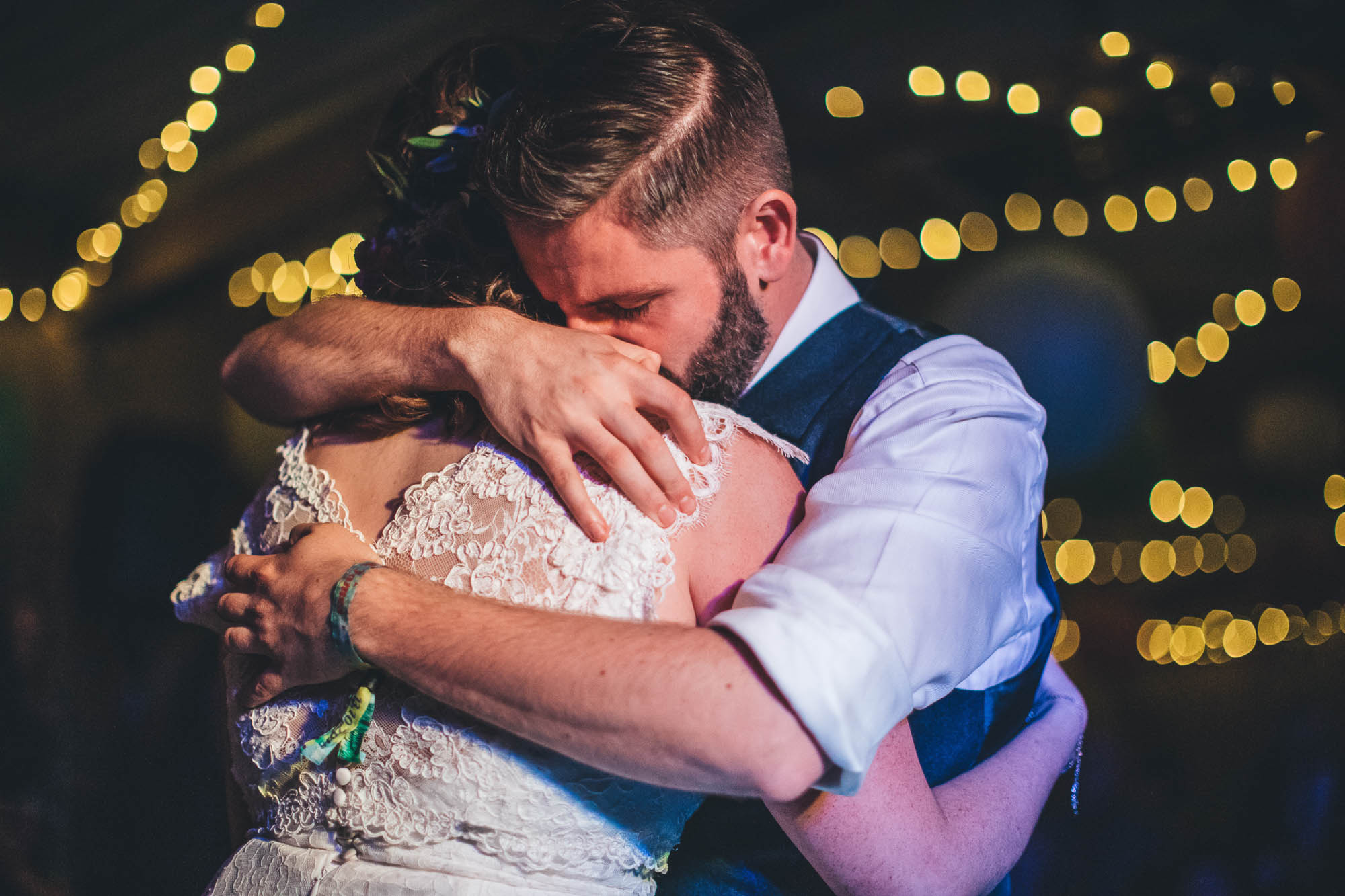 bride is being help by james in tight embrace