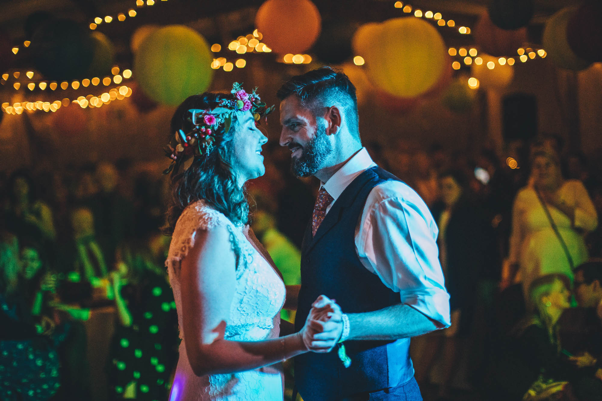 couple are lit by blue disco lights