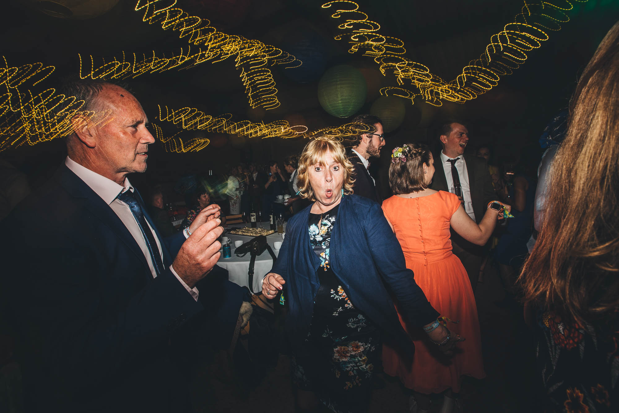 wedding guest pulls funny face on dancefloor