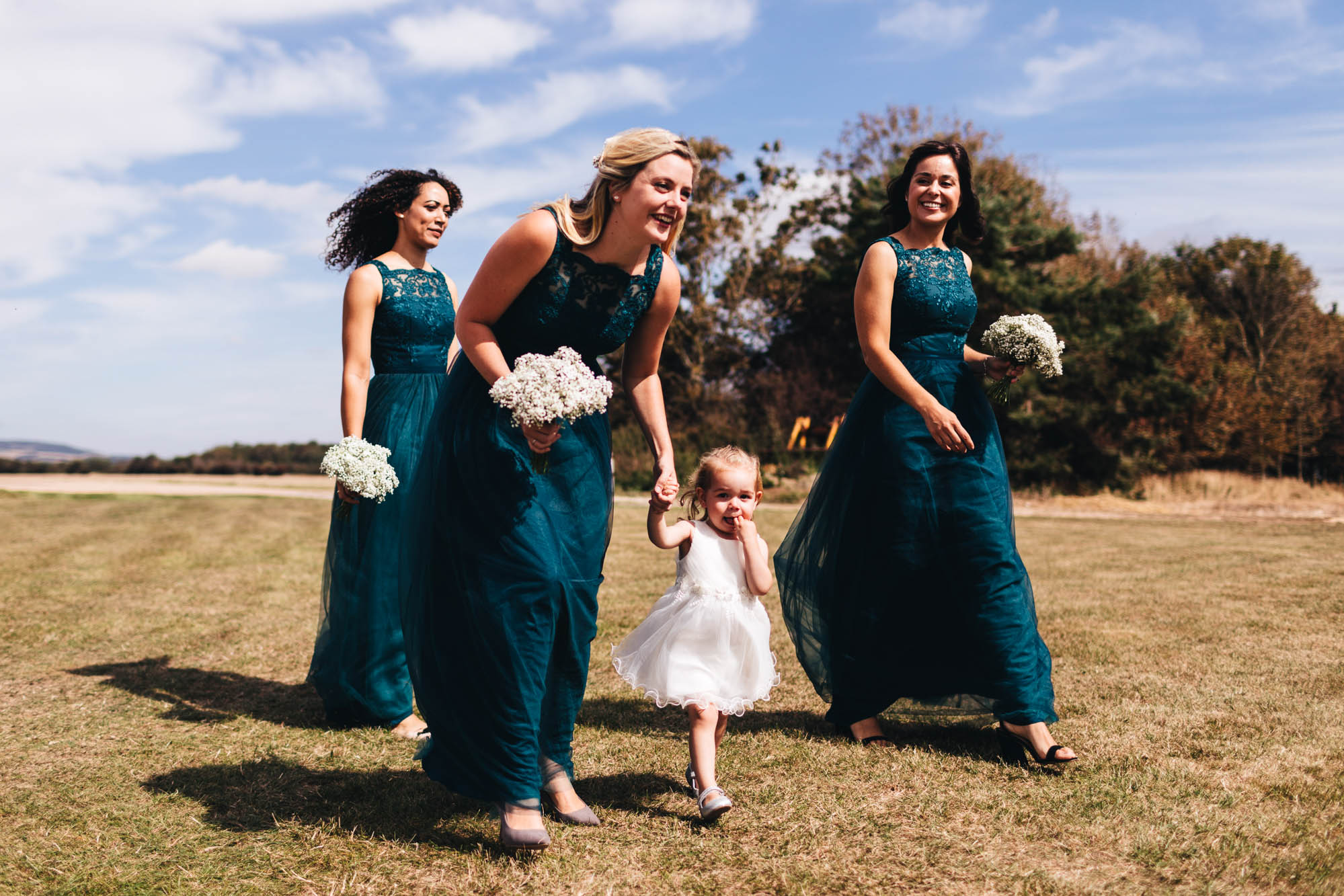 bridesmaids arrive with flower girl