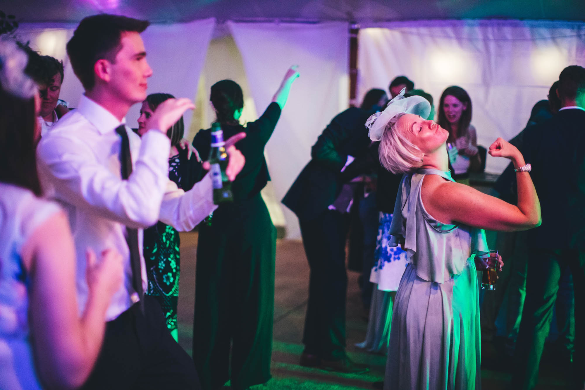 wedding guests making strange shapes on the dancefloor