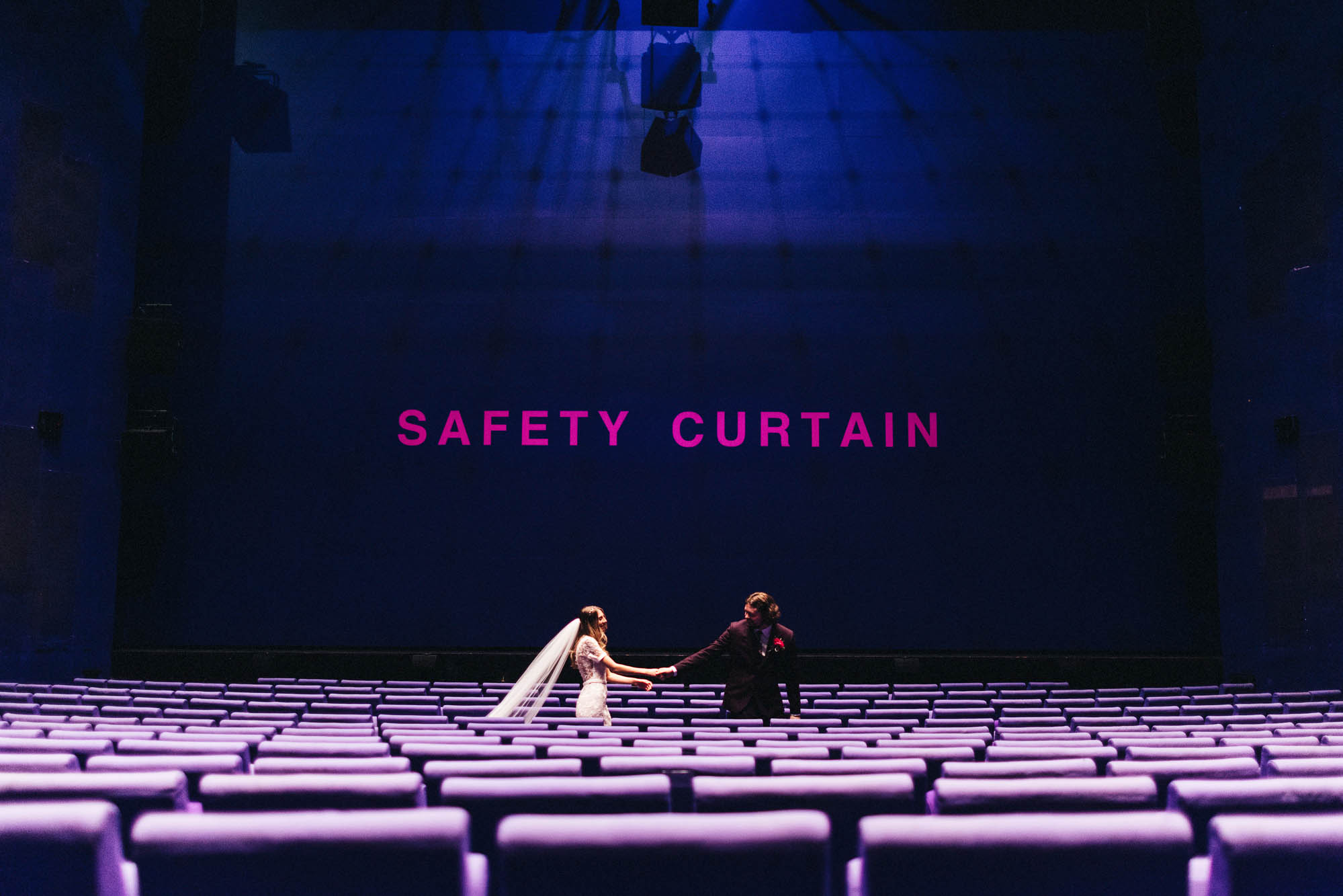 couple in lowry theatre wedding photography safety curtain