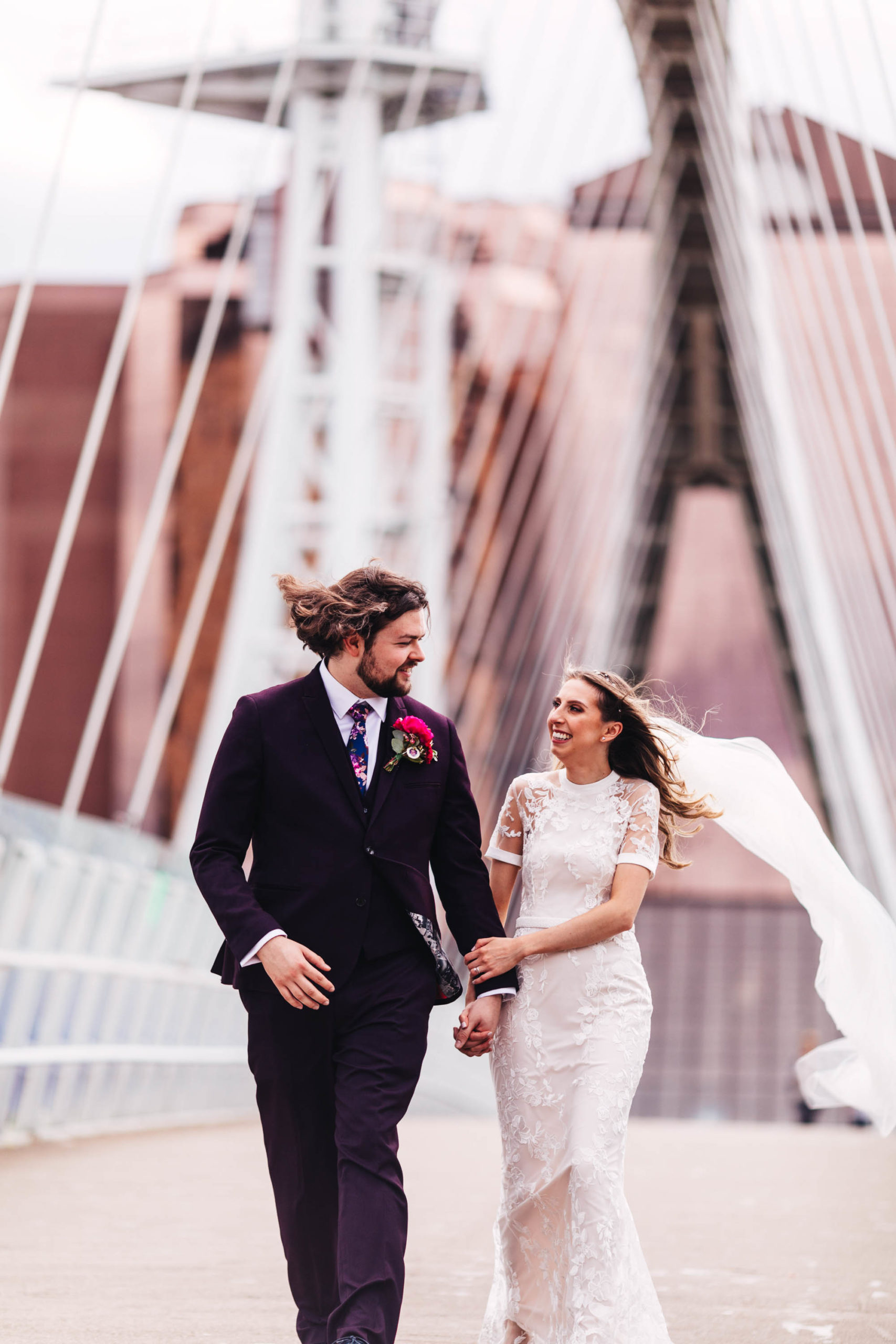 couple walk over bridge