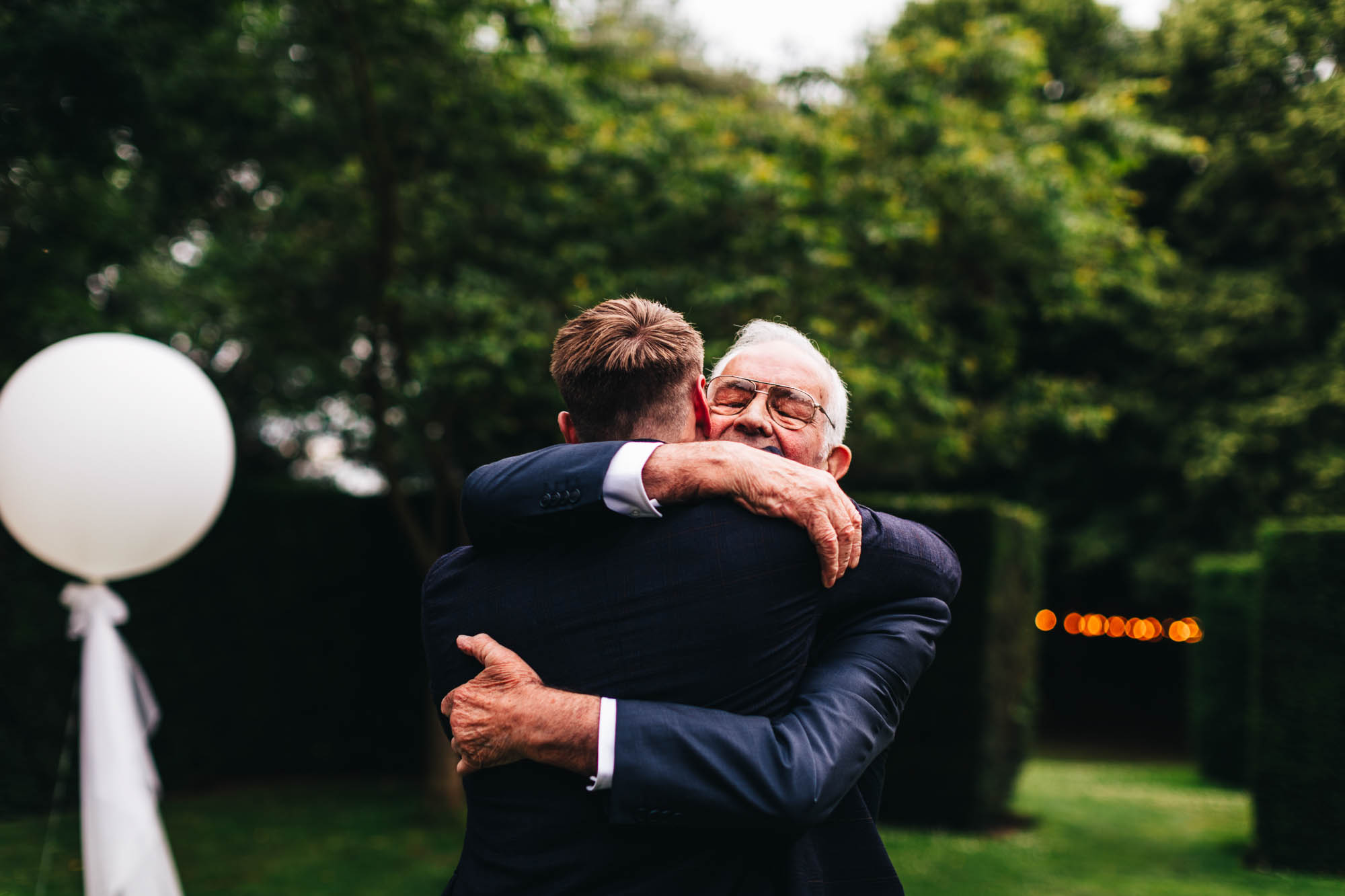 groom hugs grandad