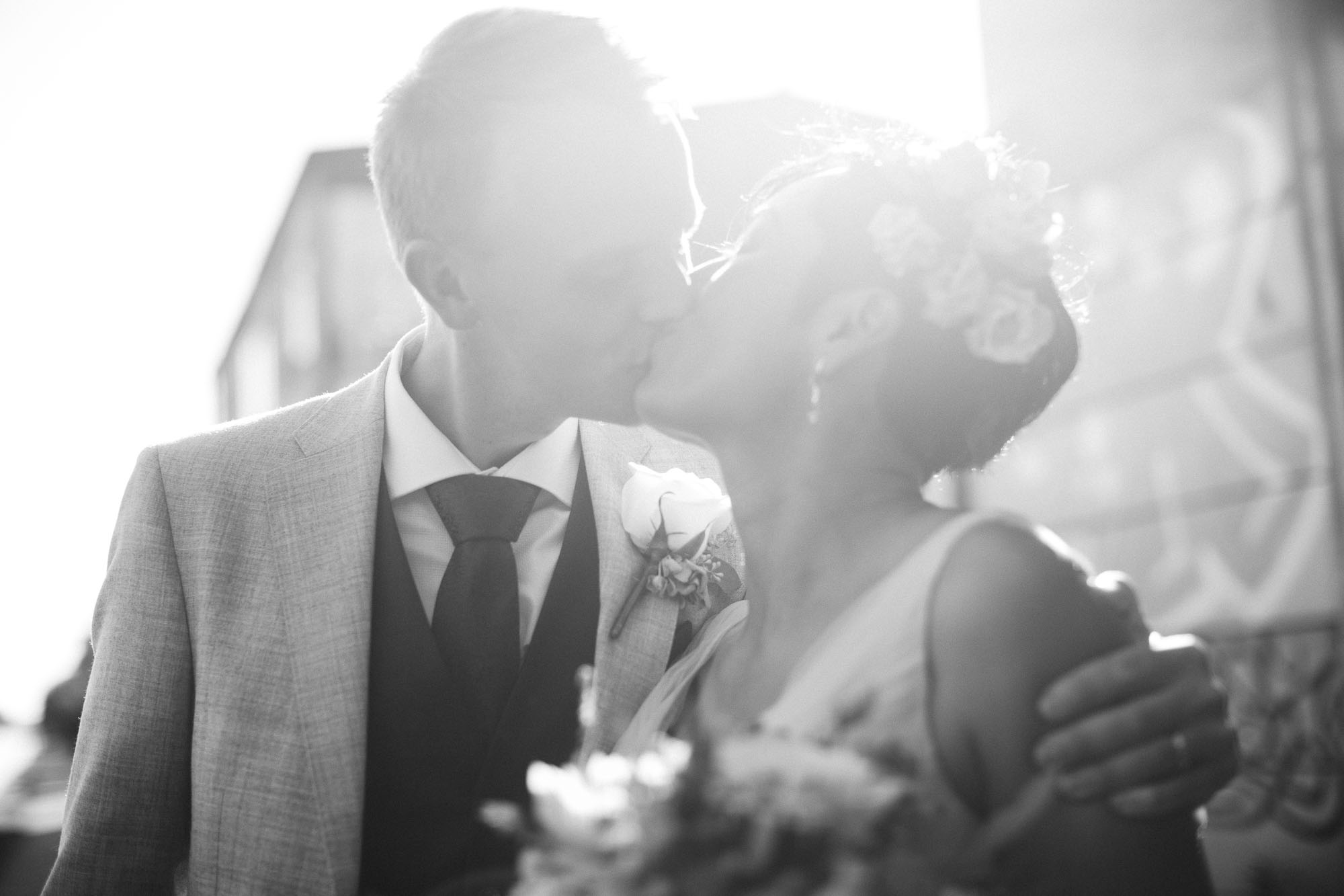 black and white bright high key shot of couple kissing