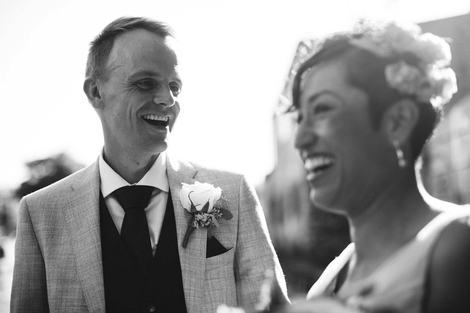 groom laughs lovingly at bride