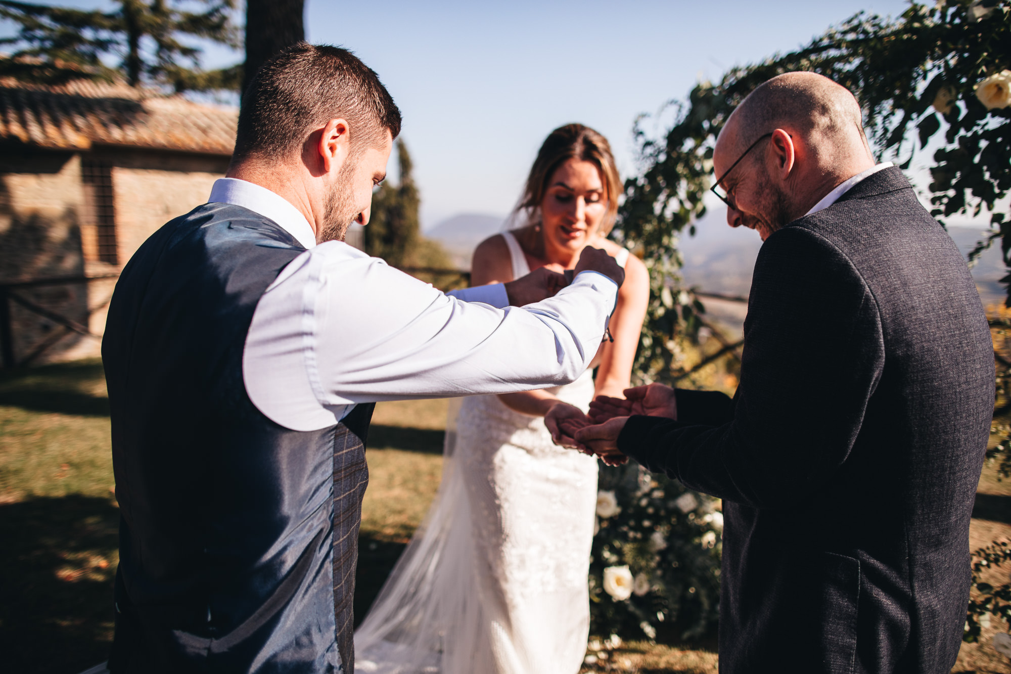 wedding rings are handed to couple during their wedding ceremony