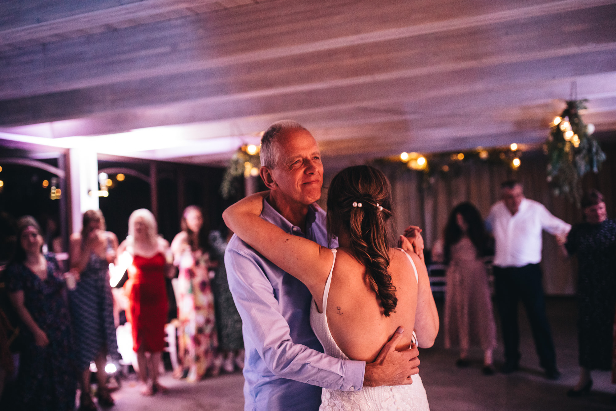 father smiles while dancing with daughter
