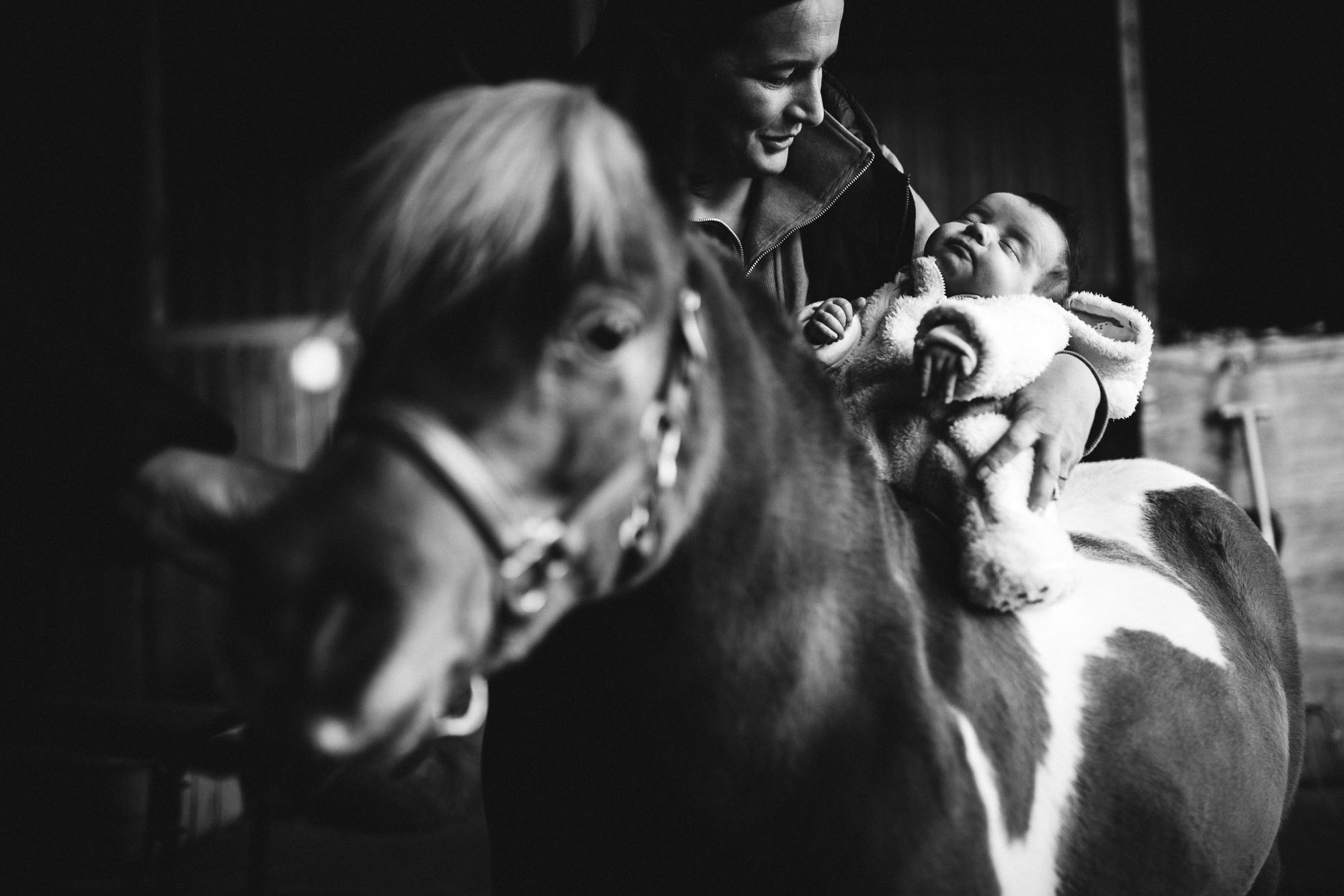 mono shot of mum placing athena on derek for the first time