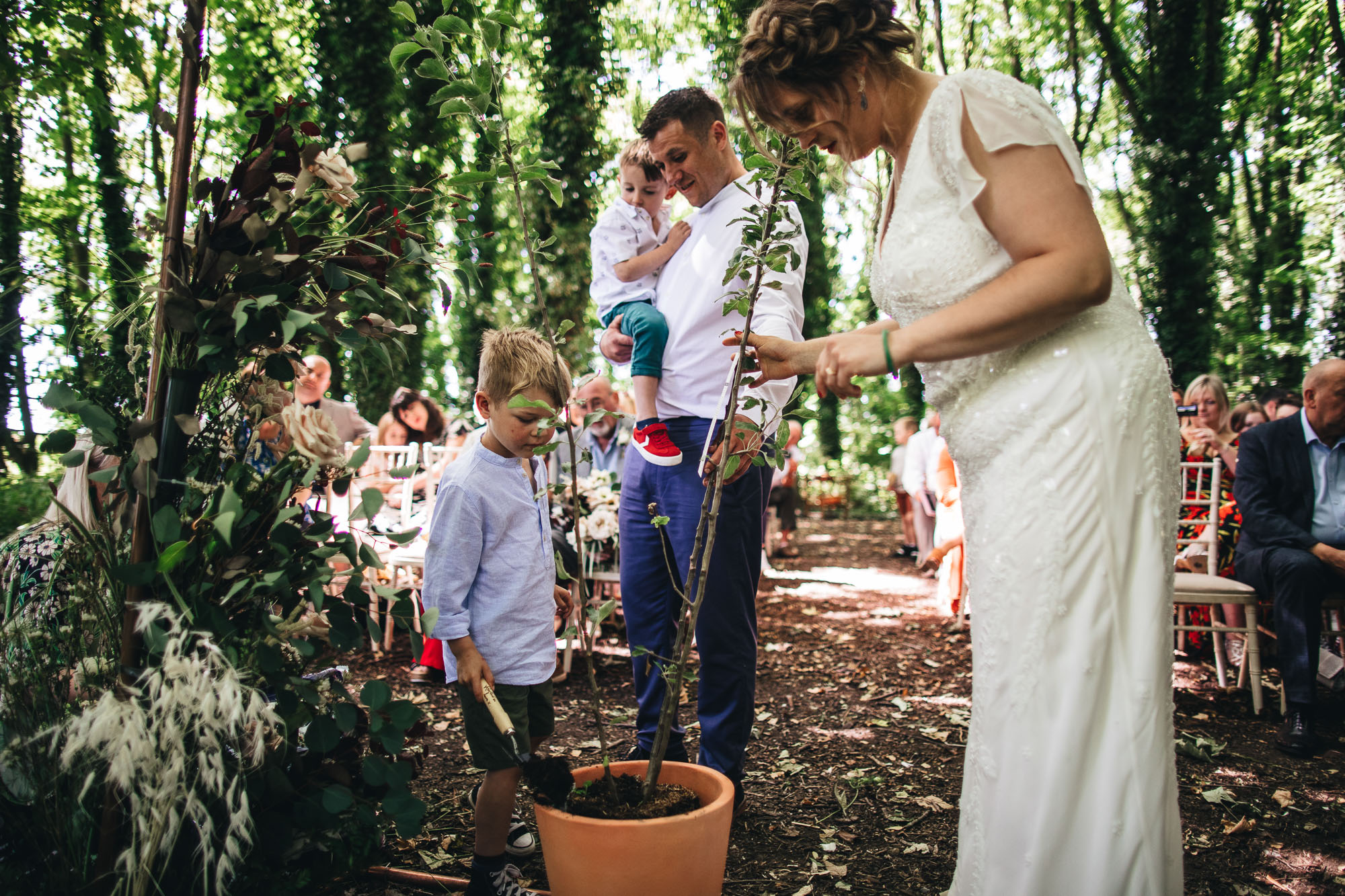 family plant tree during the humanist wedding ceremony