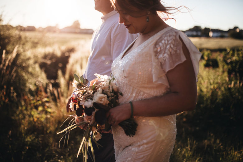 whimsical shots of Harriet holding bouquet of flowers in sunshine