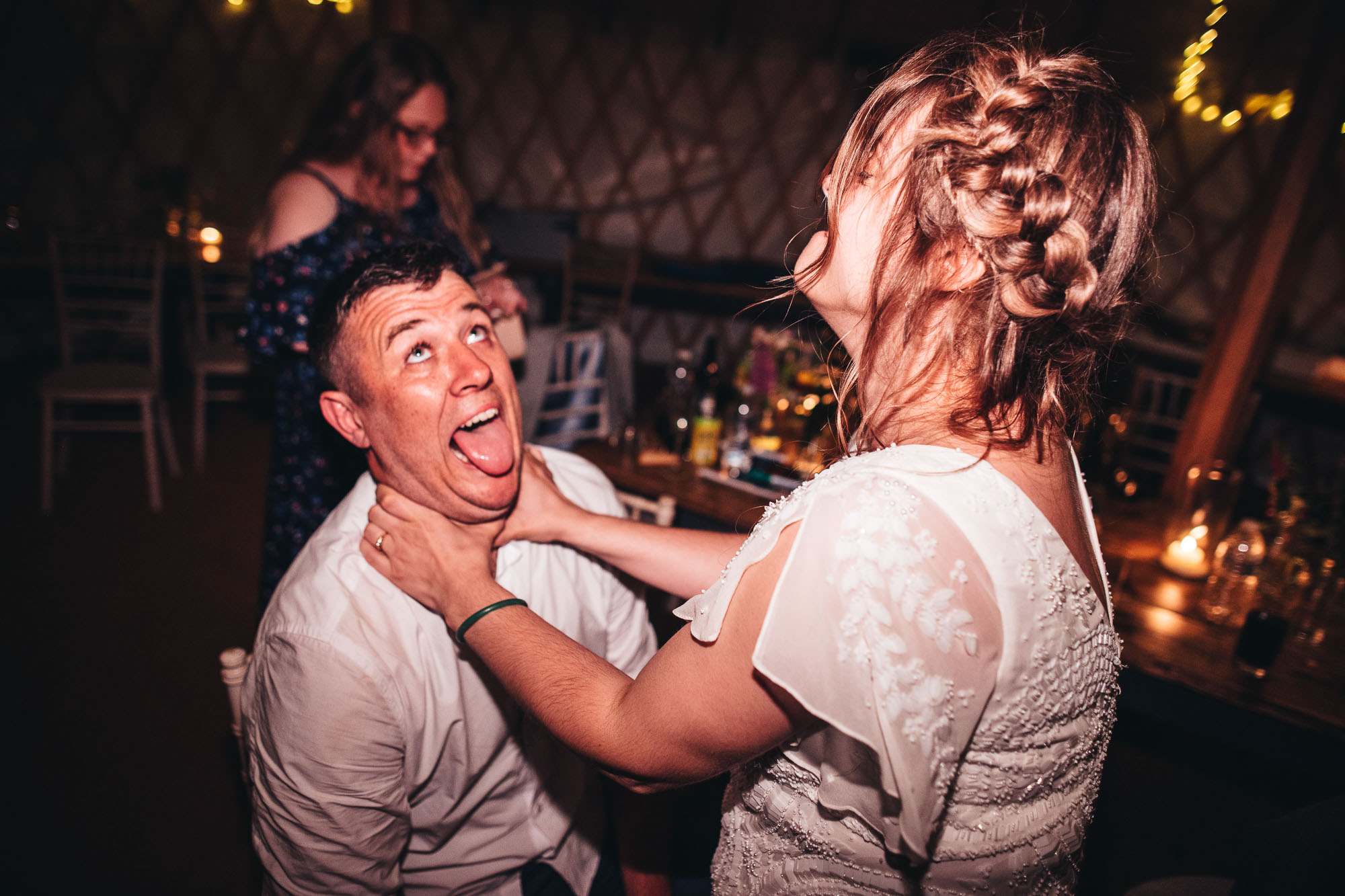 bride play strangles groom in humorous photo