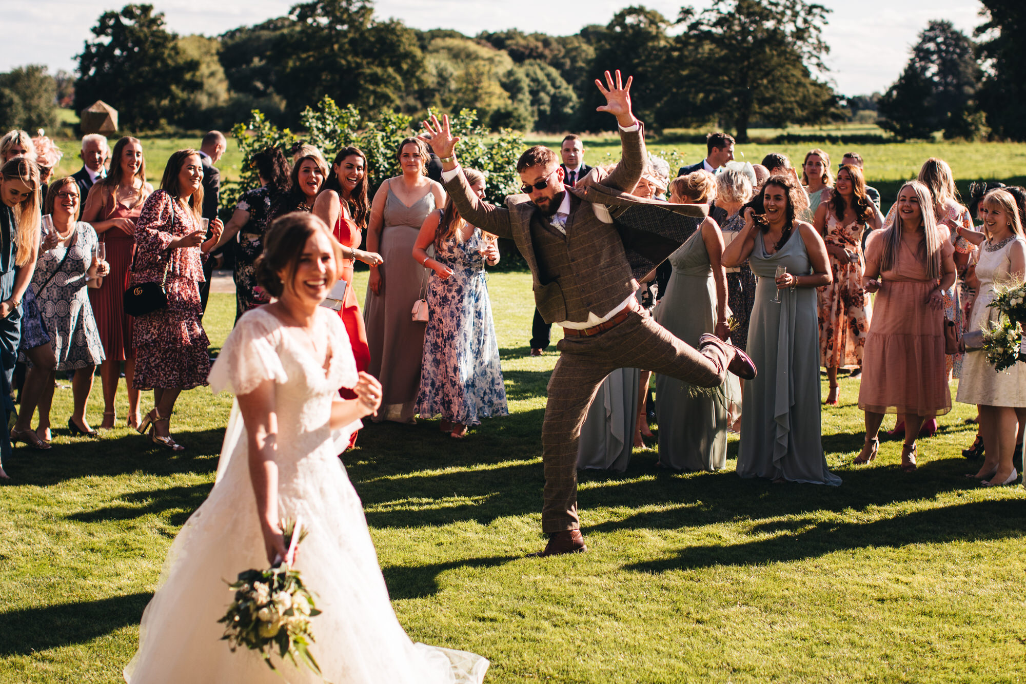 man jumps in front of crowd posing for picture