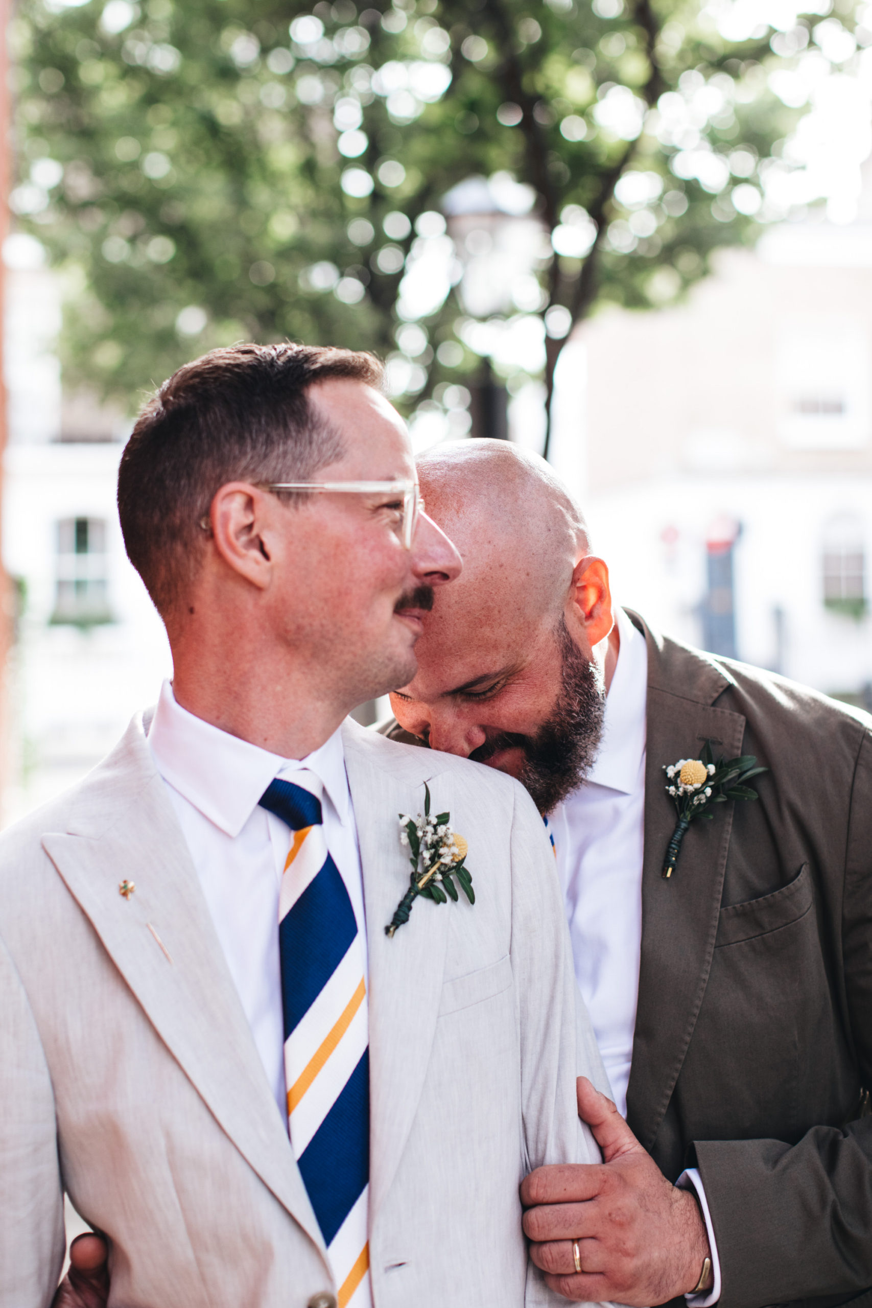 romantic shot of gay couple one with head on others shoulder