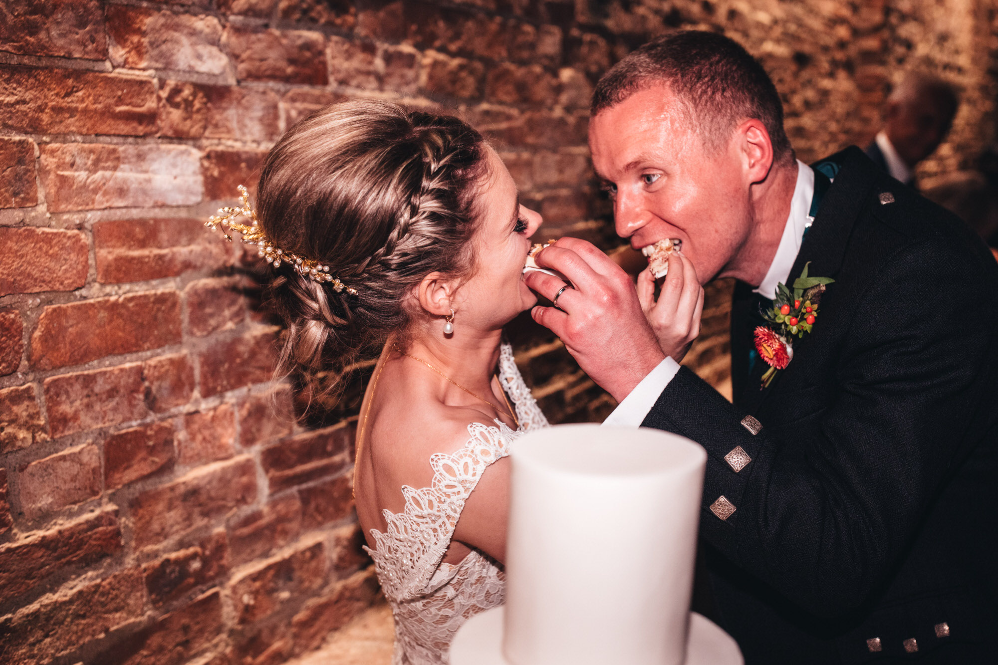 couple feed each other cake