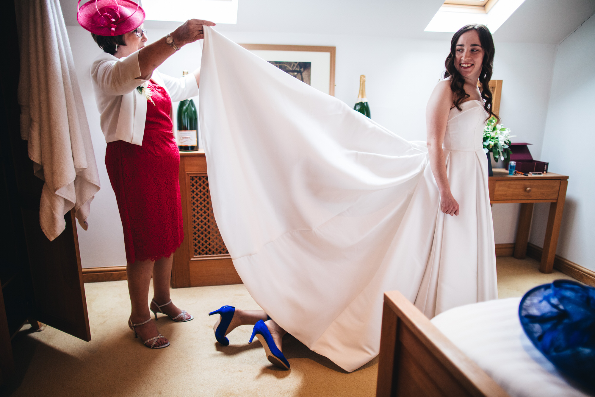 pair of shoes stick out from underneath the brides dress