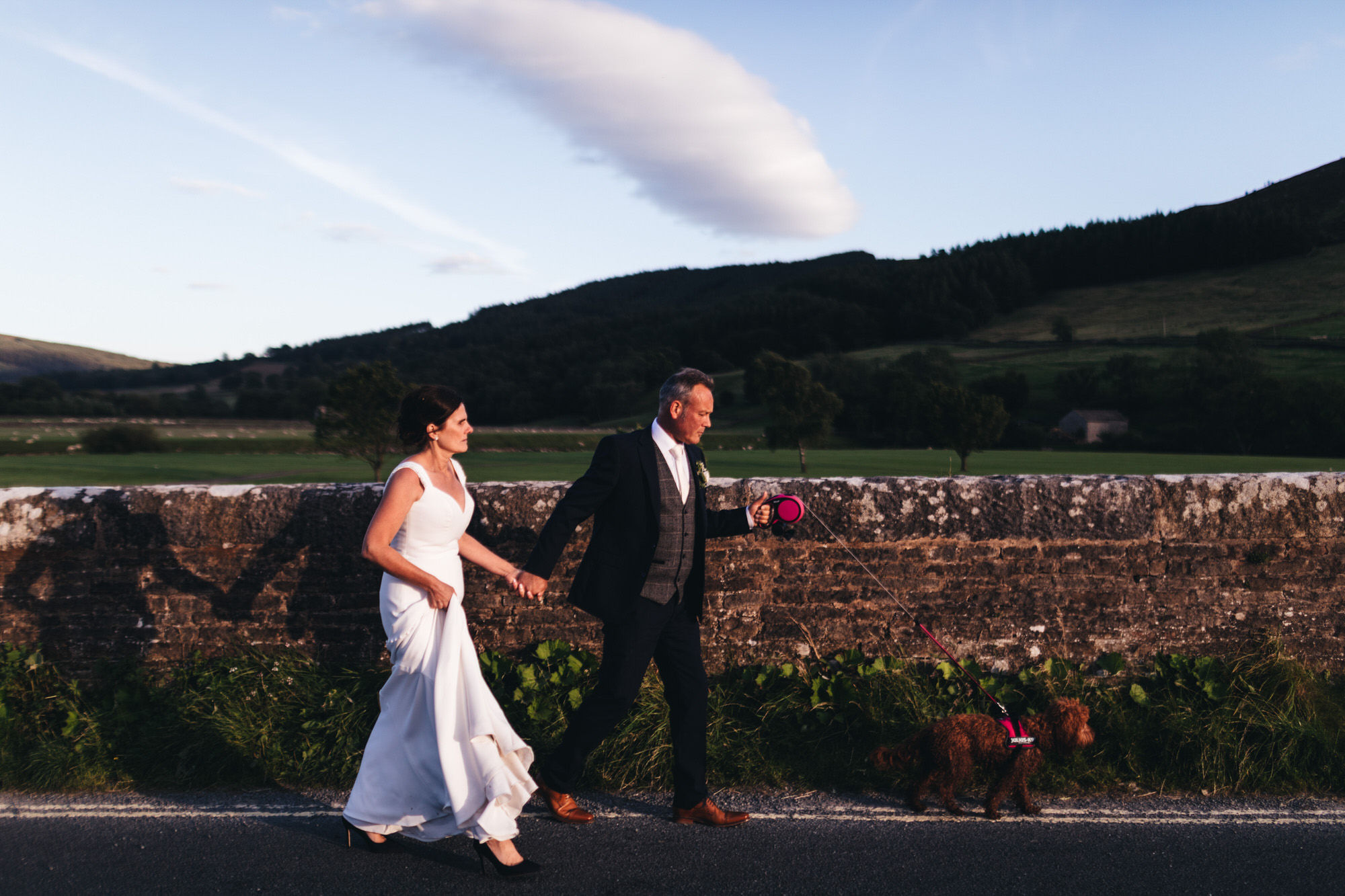 married pair walk their dog in yorkshire