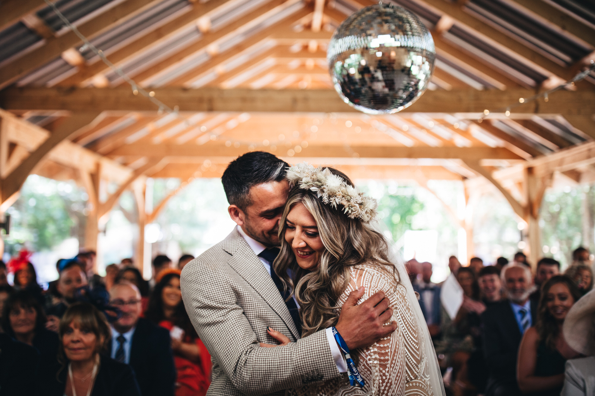 bride and groom at festival style wedding under mirror ball