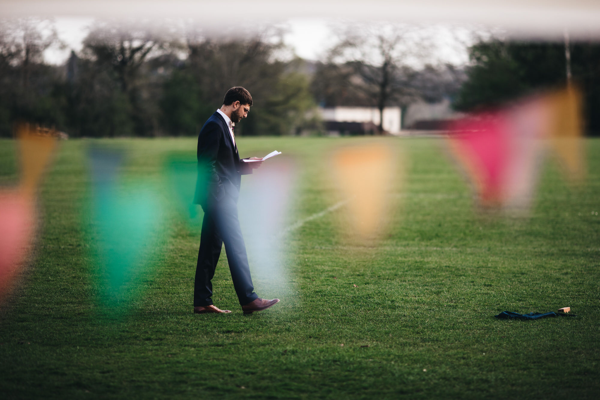 groom walks across field practicing his speech