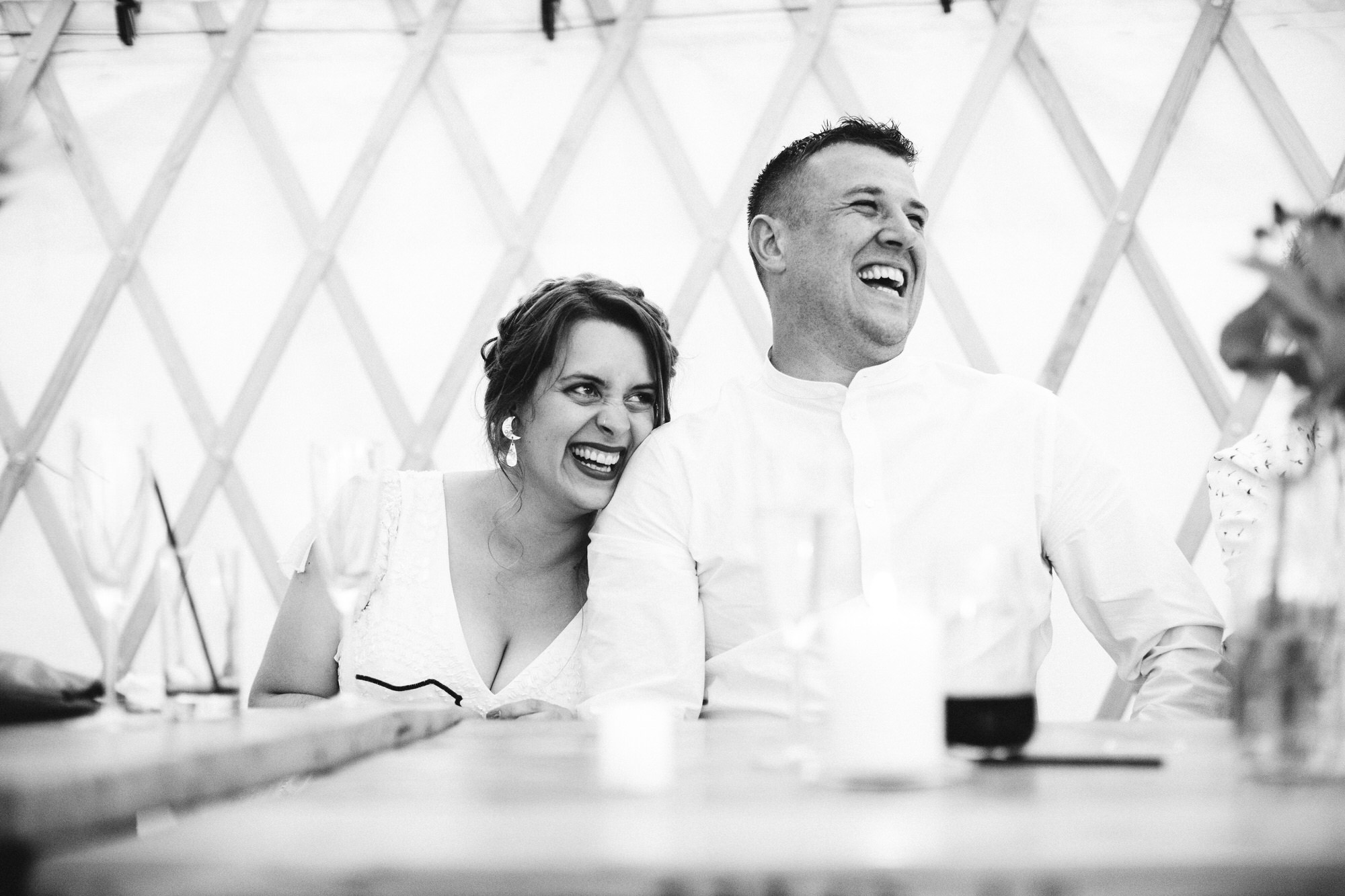 mono shot of couple laughing during speech together