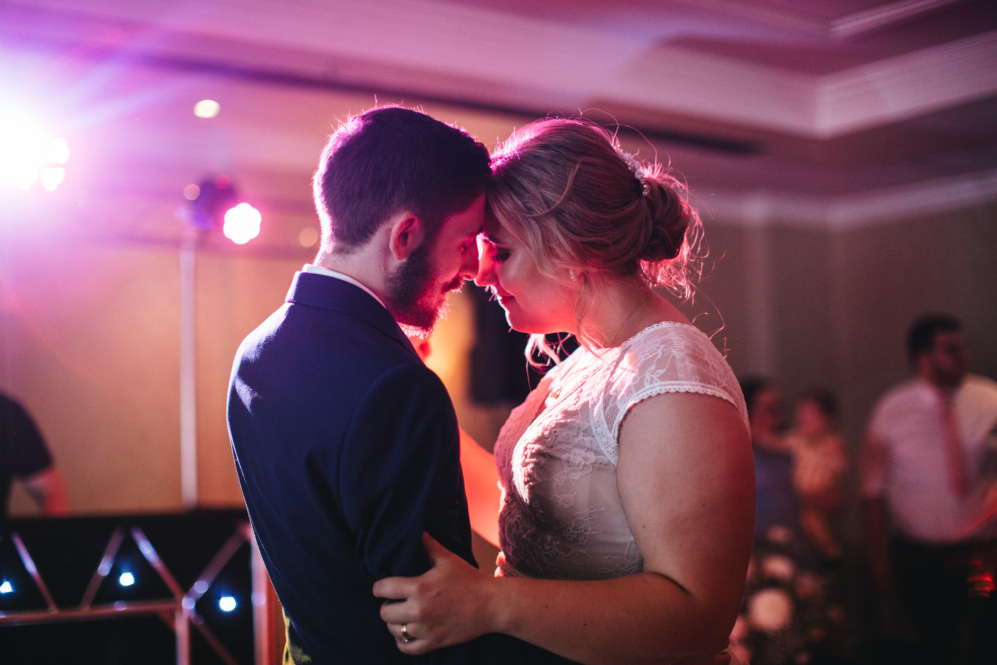 first dance heads together pink light