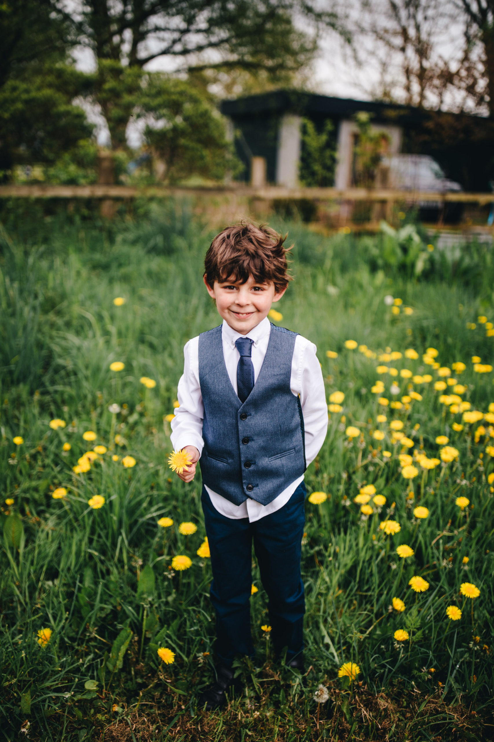 boy holds flower in field