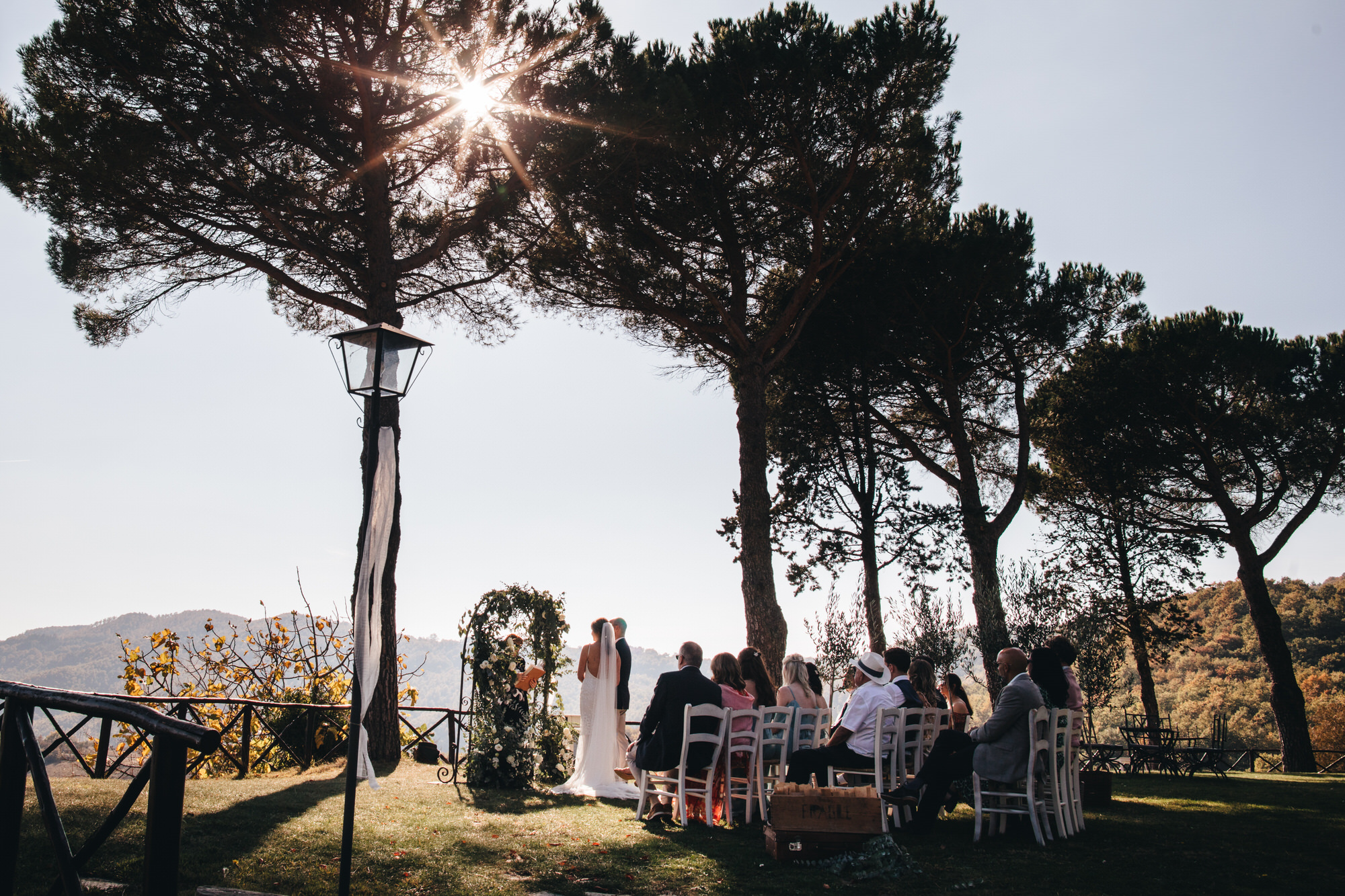 sun streams in through trees in italy wedding