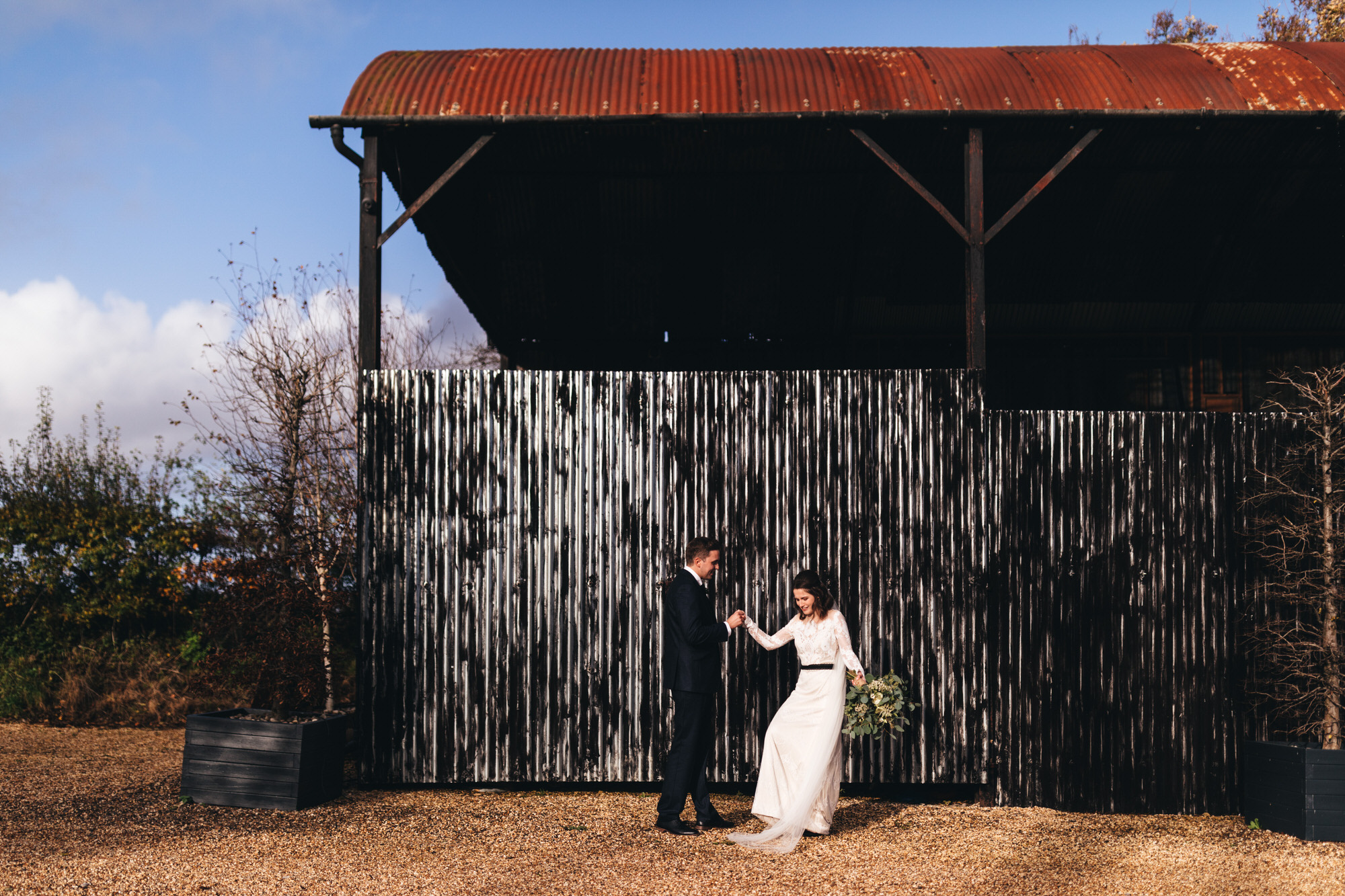 bride dances by barn