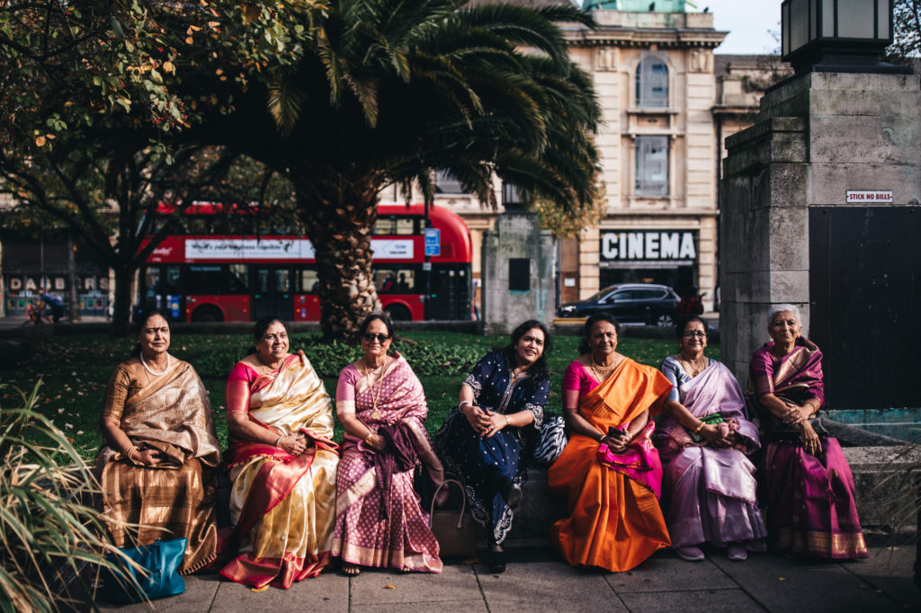 Indian women sit on wall