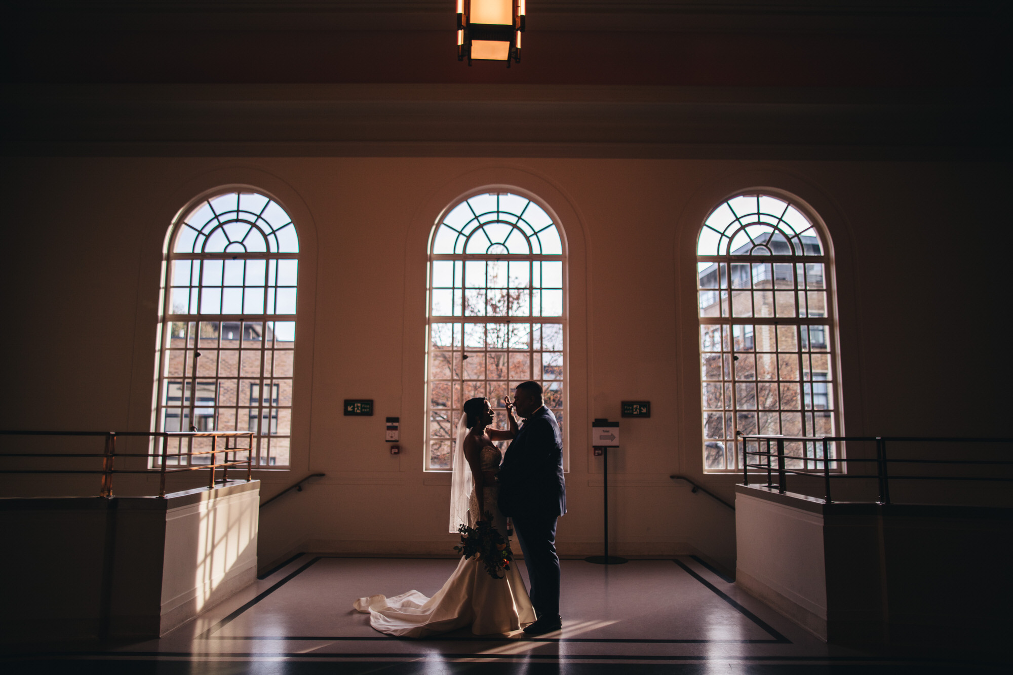 bride touches grooms nose in romantic funny portrait