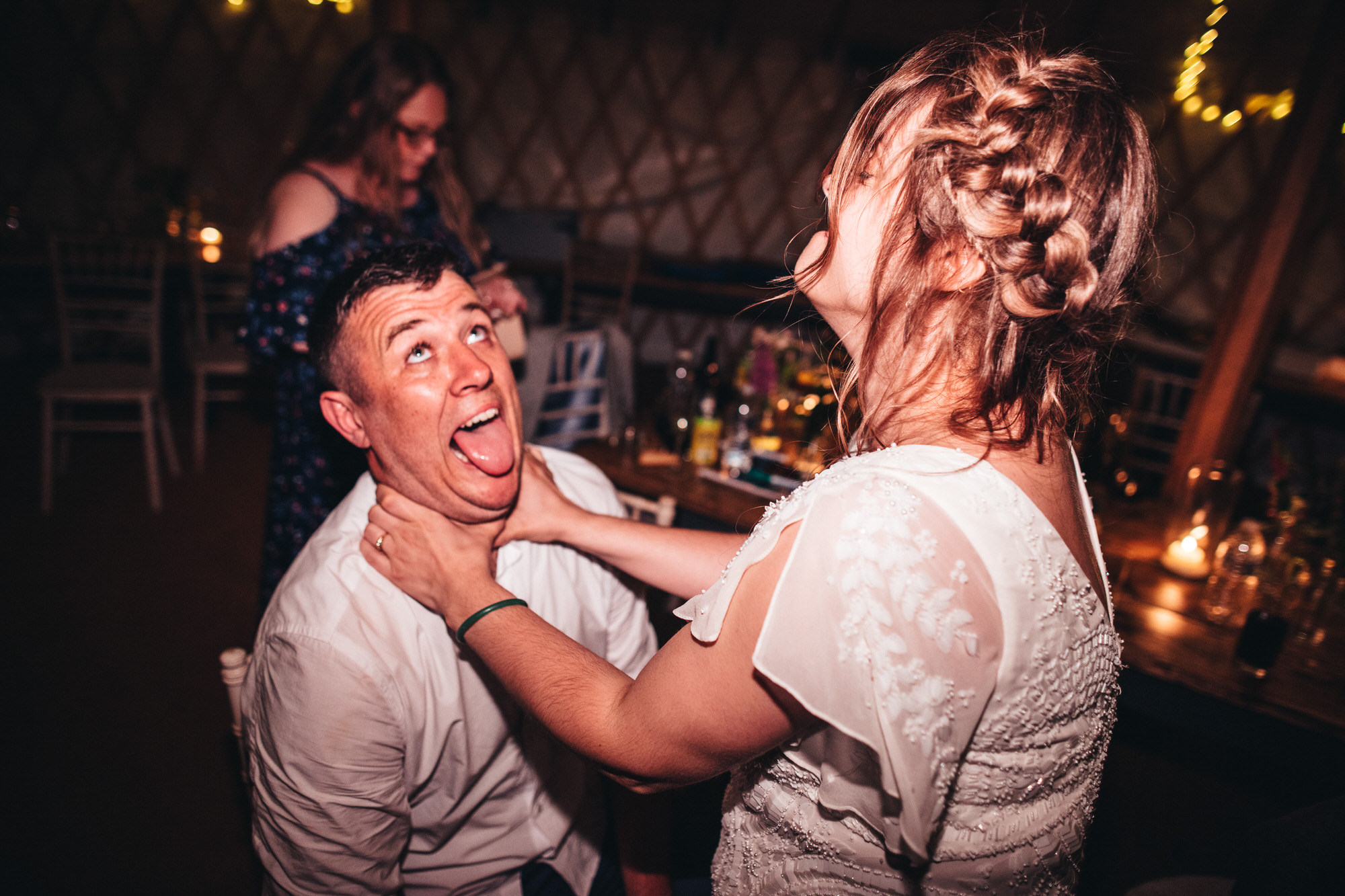 bride strangles groom in joking manner