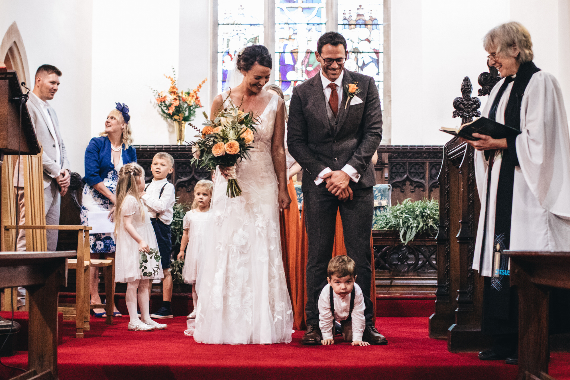 child on floor in church at wedding