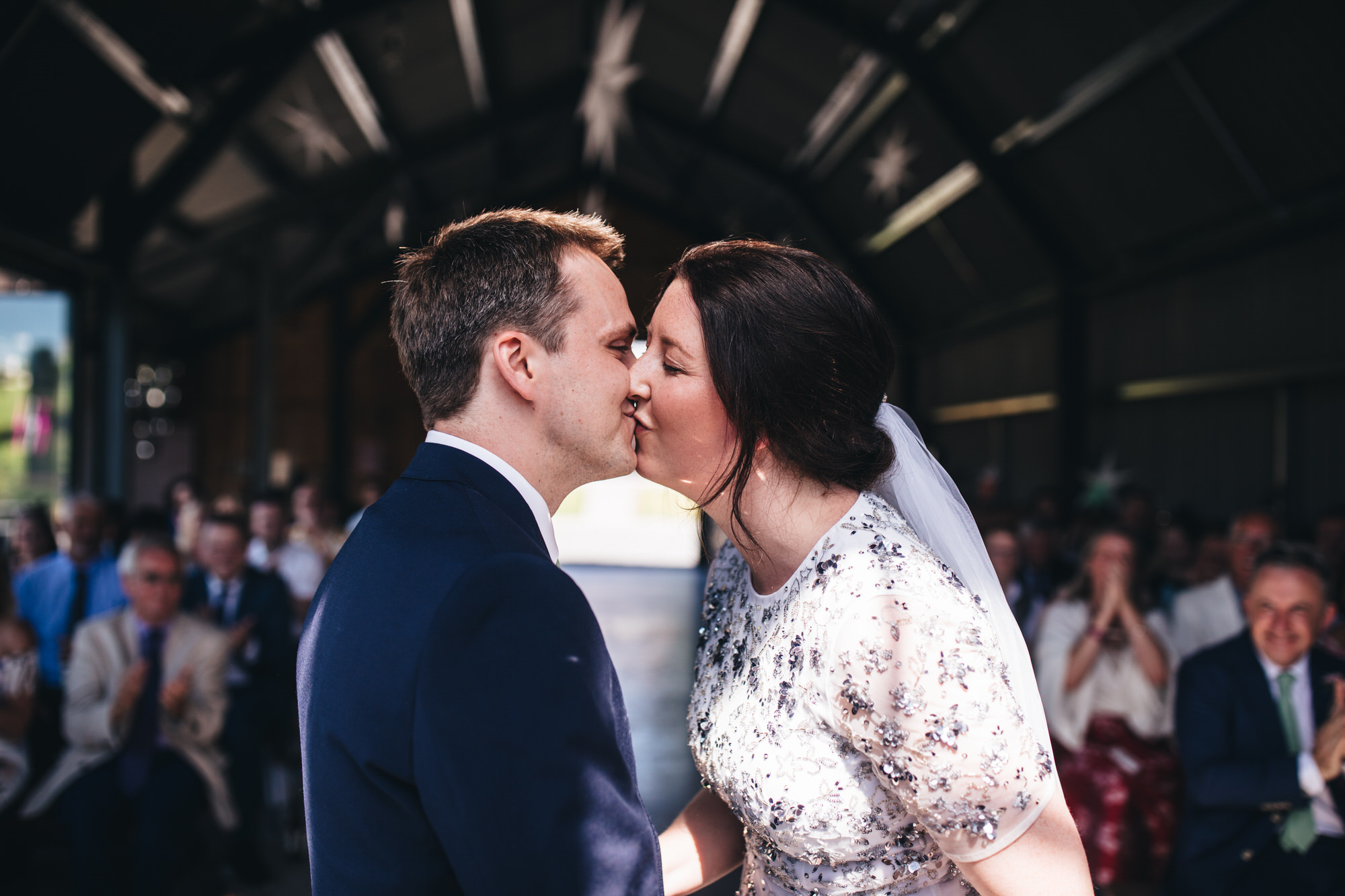 couple kiss after ceremony at wedding