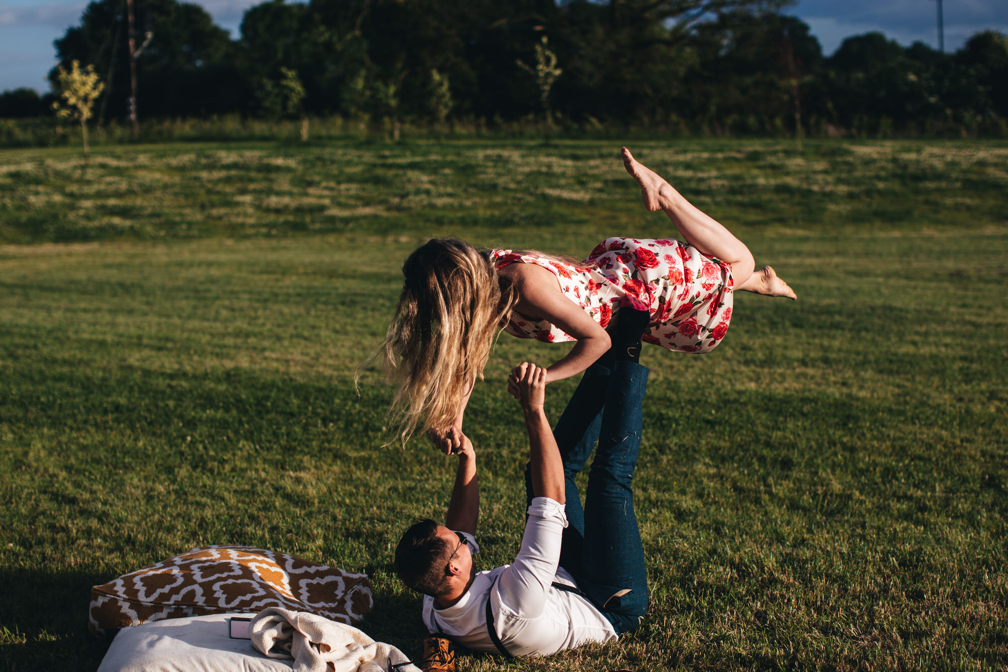 woman is lifted up by man on the grass