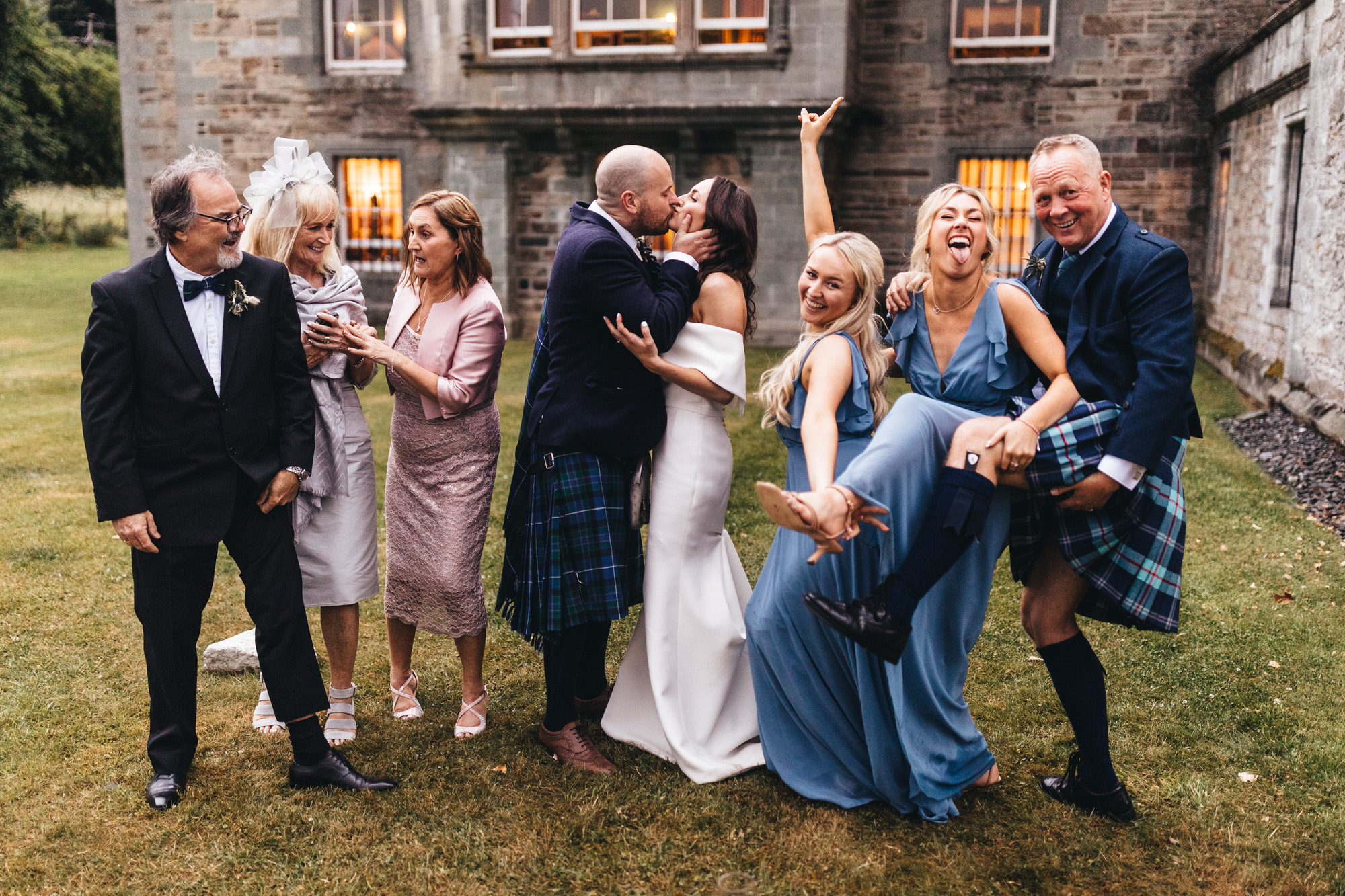 funny faces in wedding group picture
