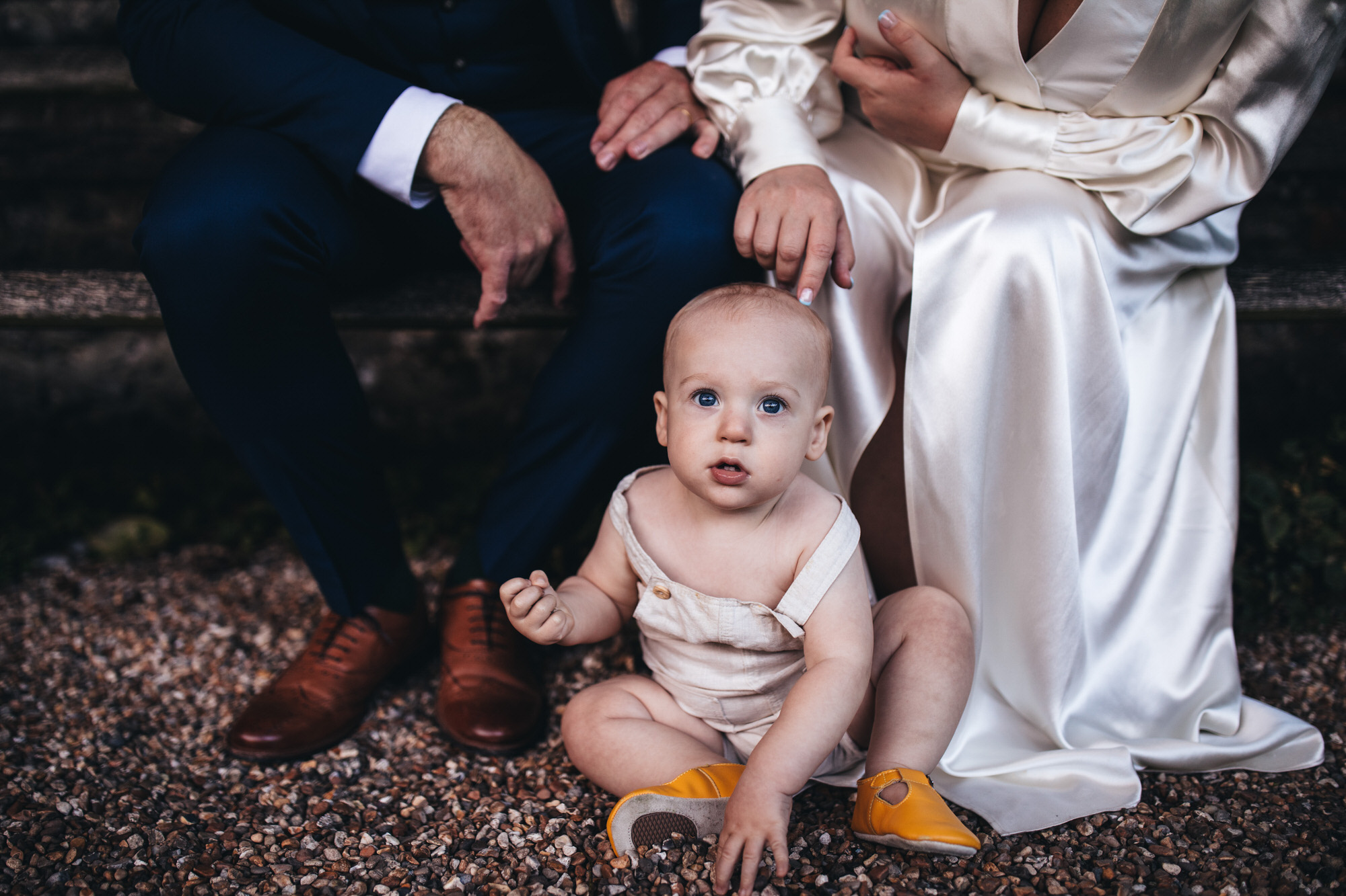 baby poses in front of couple
